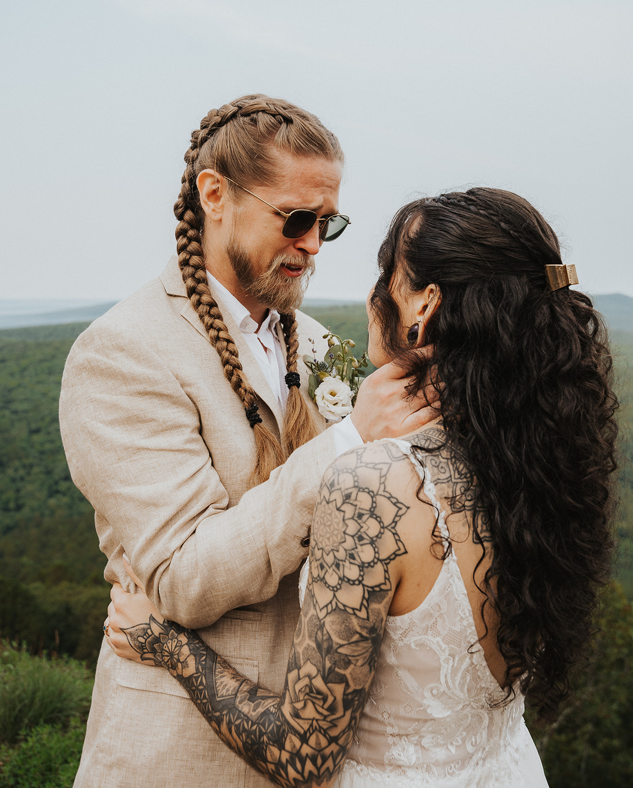 a groom holding his wife and crying after a first look on their elopement day