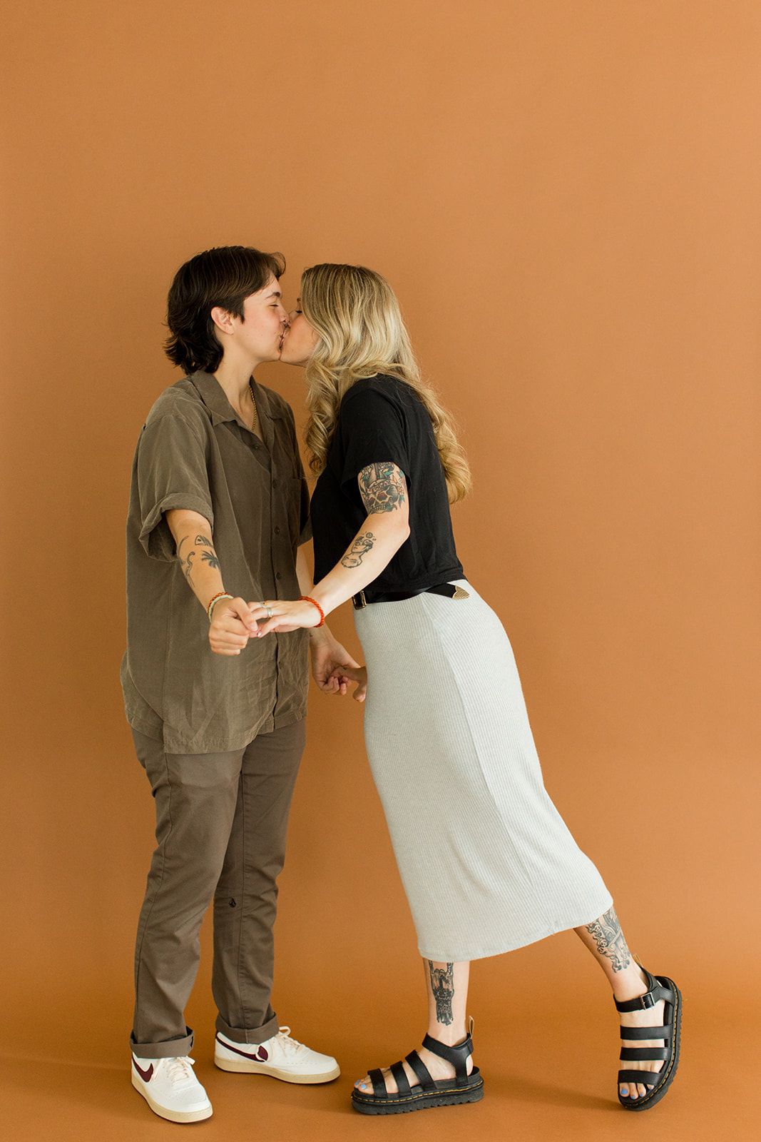  A photo of a couple kissing in front of a backdrop