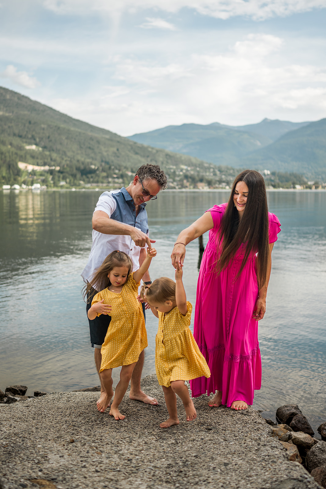 family dancing in front of Kootenay Lake