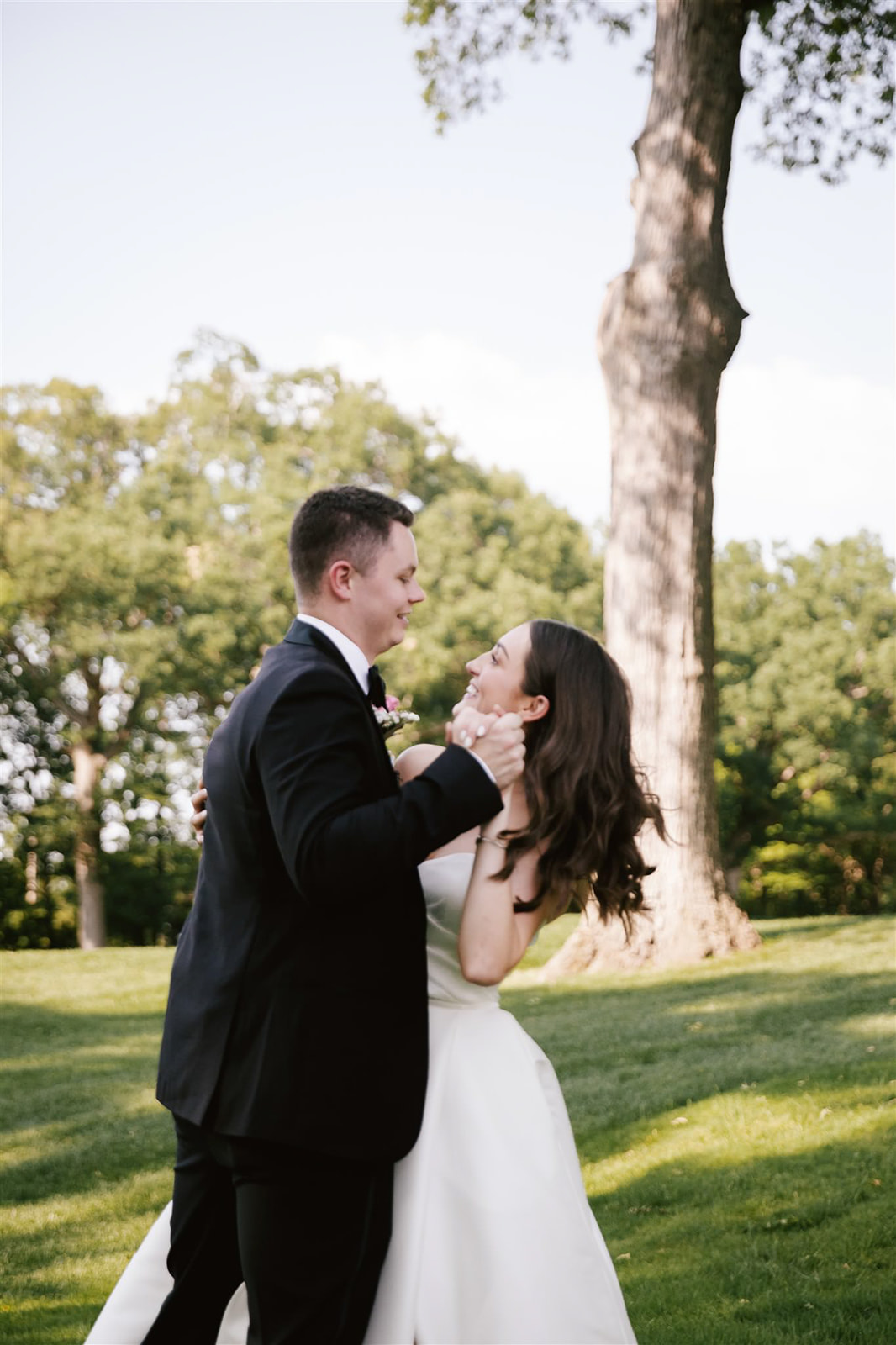 Dancing into the sunset, the bride and groom share a romantic moment enveloped in the warm glow of evening light.