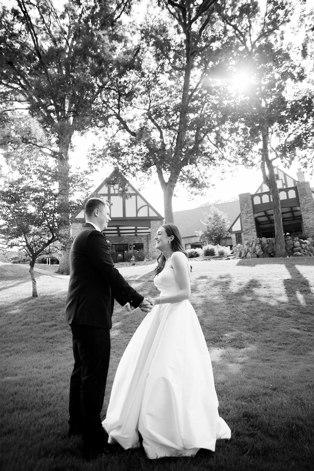 Dancing into the sunset, the bride and groom share a romantic moment enveloped in the warm glow of evening light.