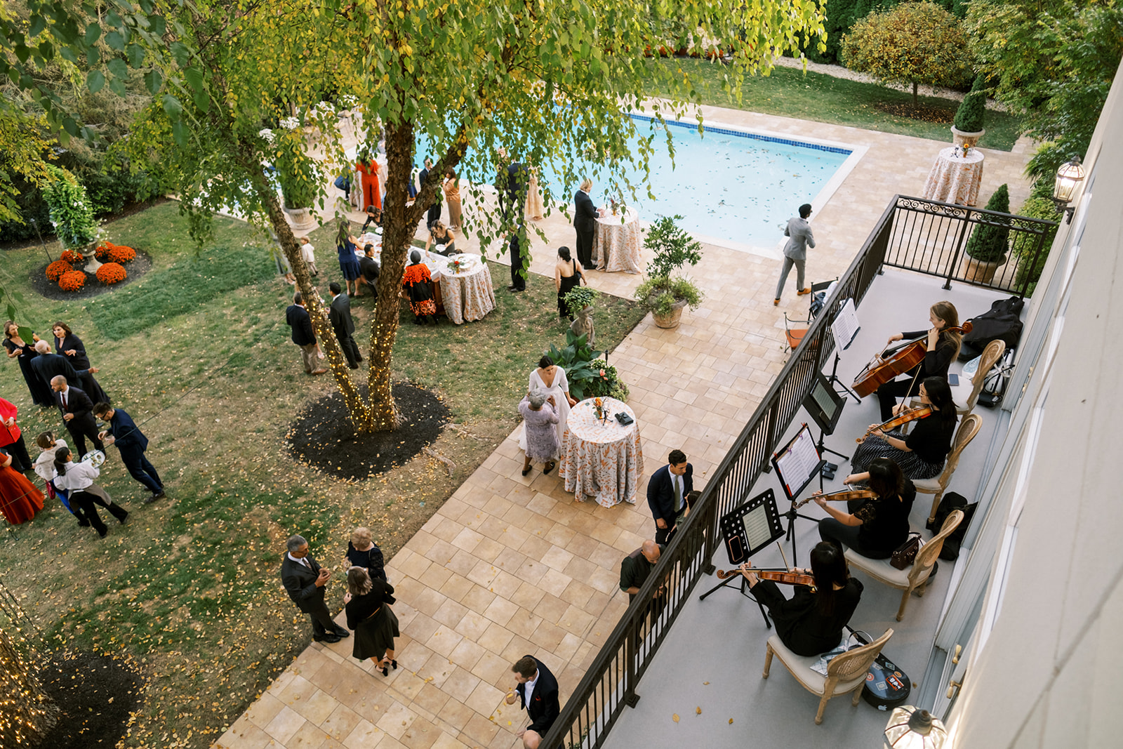 balcony view of backyard cocktail hour next to the pool at private residence maryland wedding