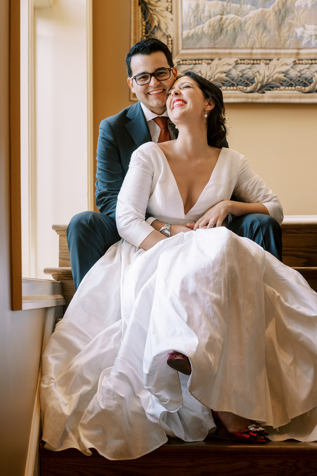 bride and groom sitting and laughing on stairs of private residence maryland backyard weddng