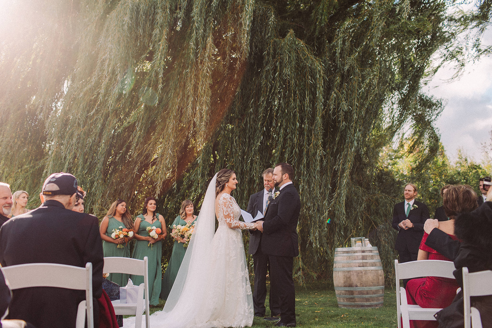 A wedding ceremony under a willow tree at Northern Michigan's gorgeous Aurora Cellars