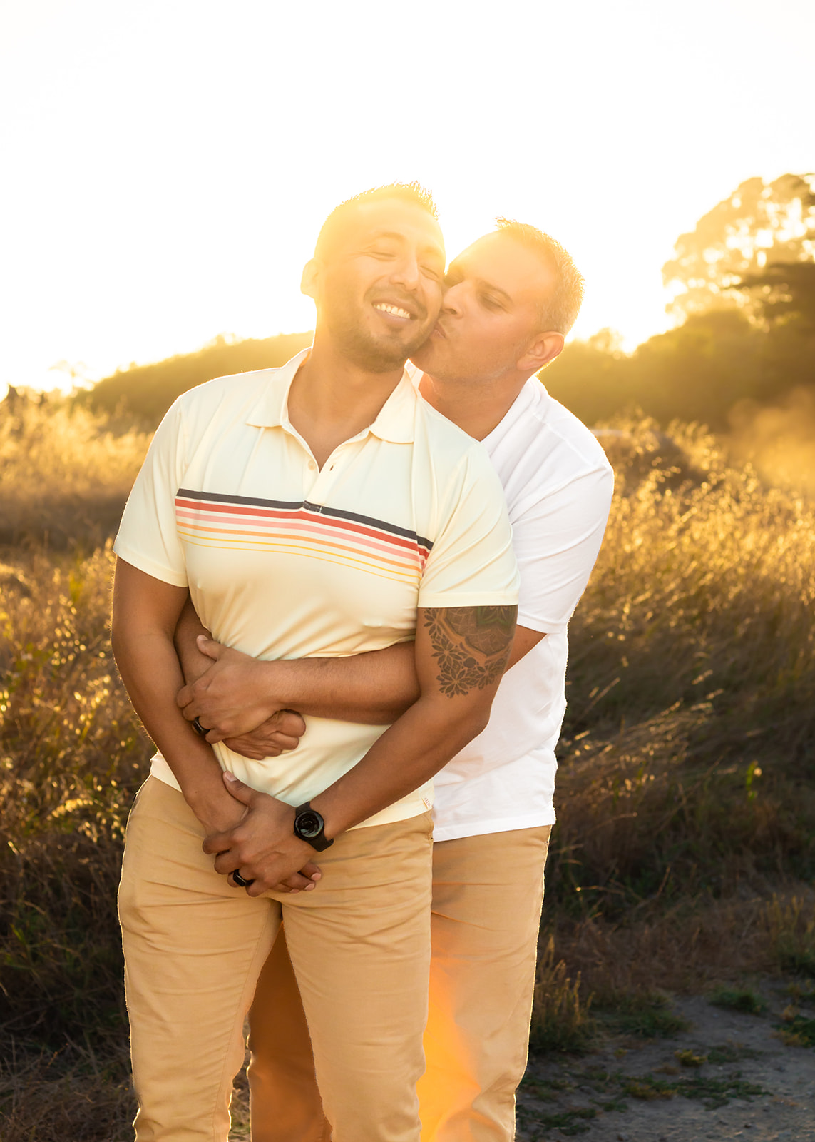 gay couple golden hour embracing