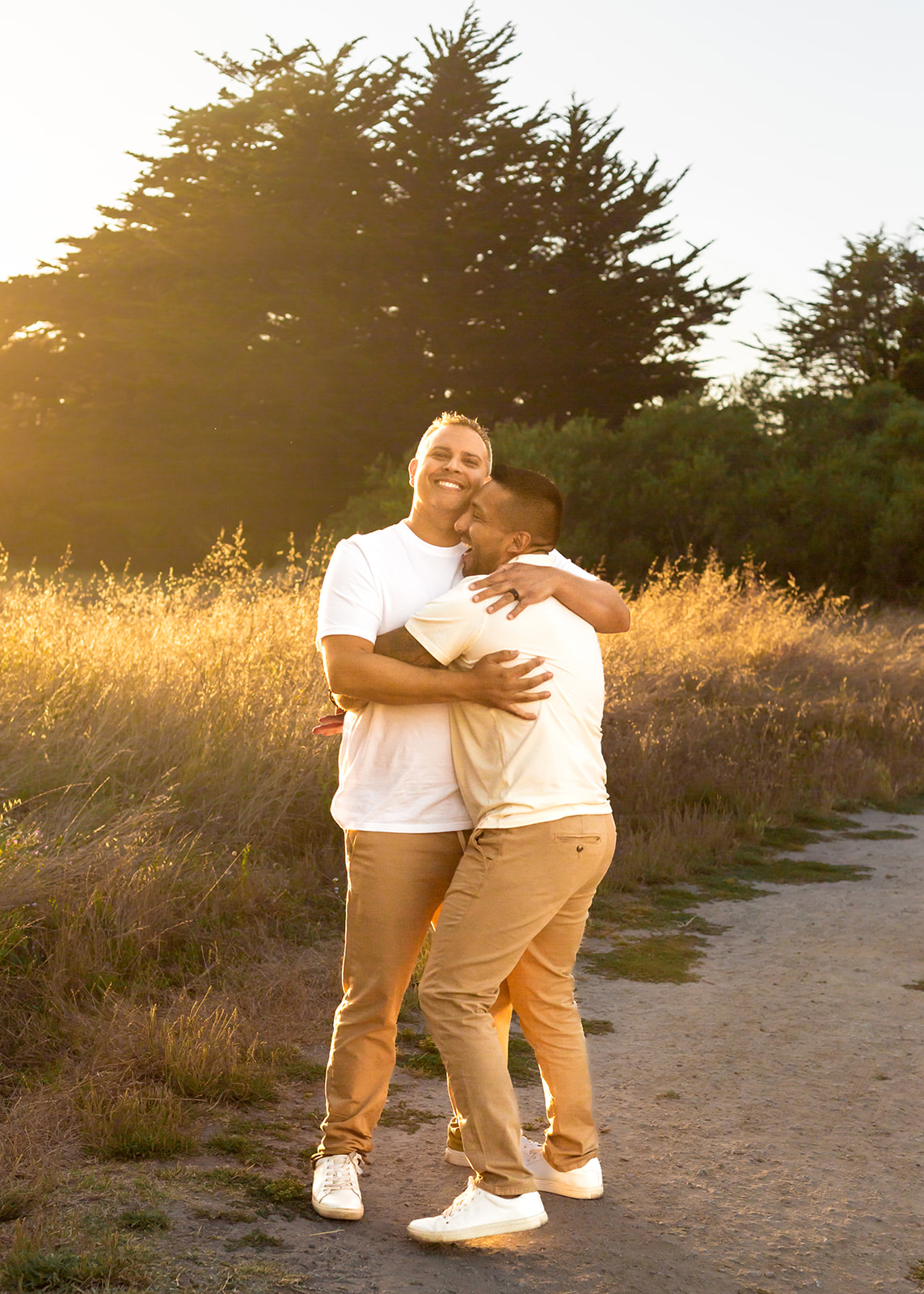 gay couple golden hour embracing