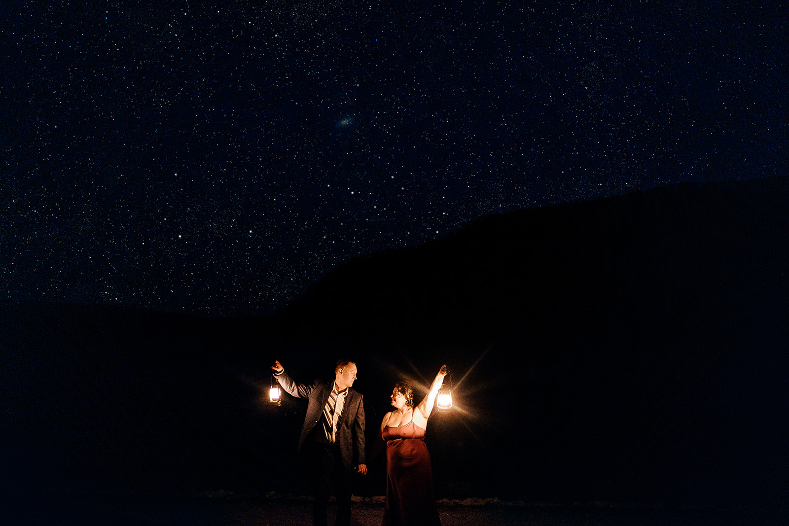 Bride and Groom are stand on the lake shore with stars aglow during their Devil's Lake State Park eleopment.