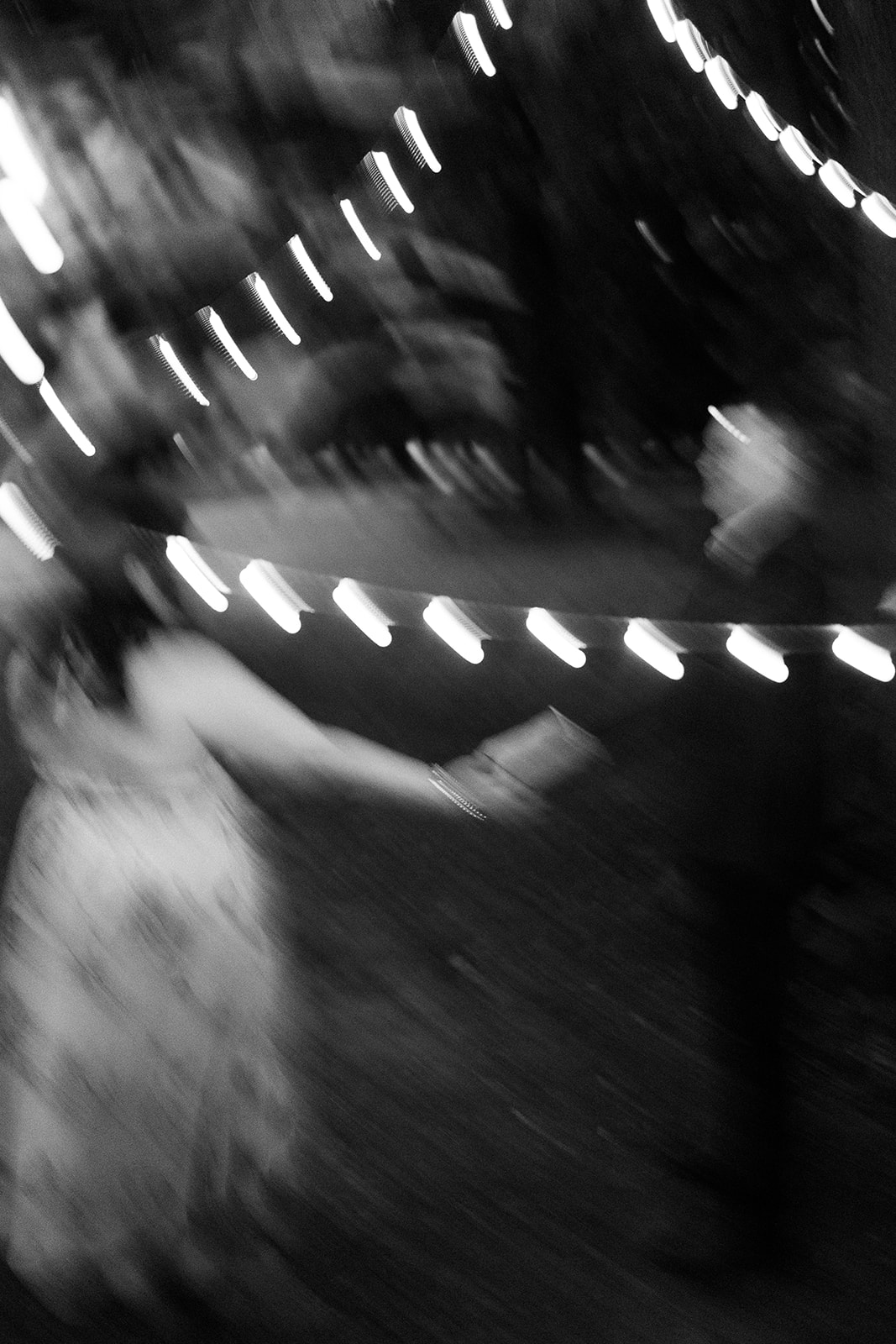 Bride and Groom twirl under twinkling lights during their intimate elopement at Devil's Lake State Park.