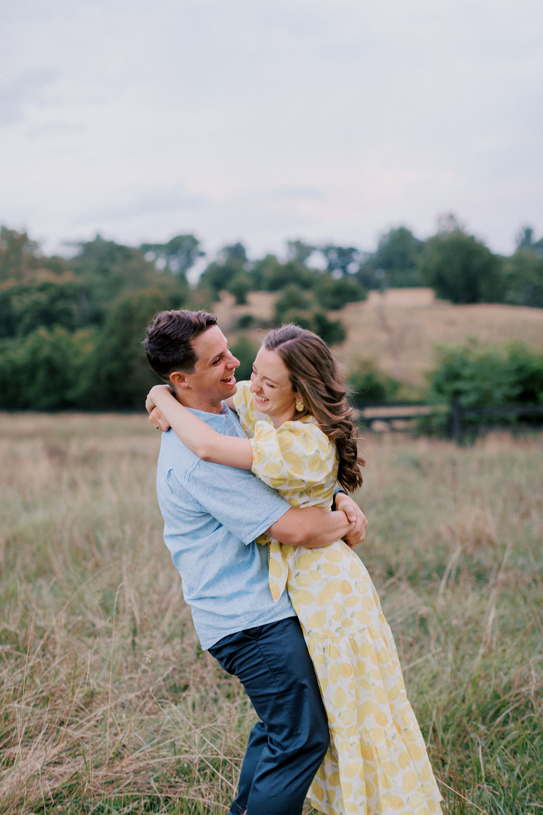 Couple hugs in a field Warrenton engagement portraits