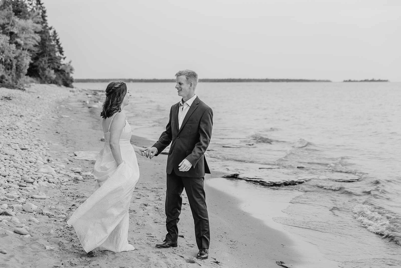 Black and white image of couple dancing on the Lake Michigan shores