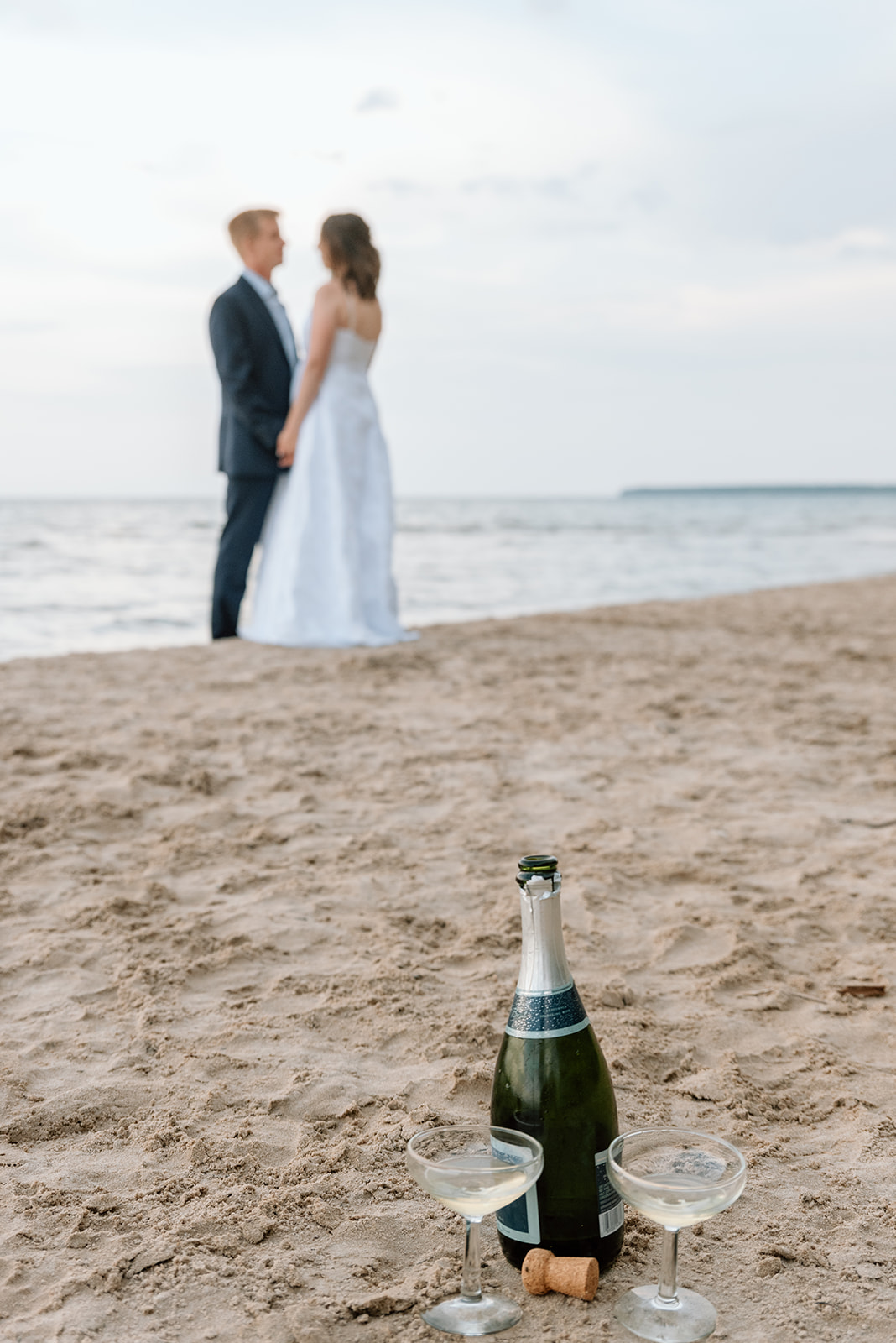 Couple toasts to their vow renewal on the shores of Lake Michigan