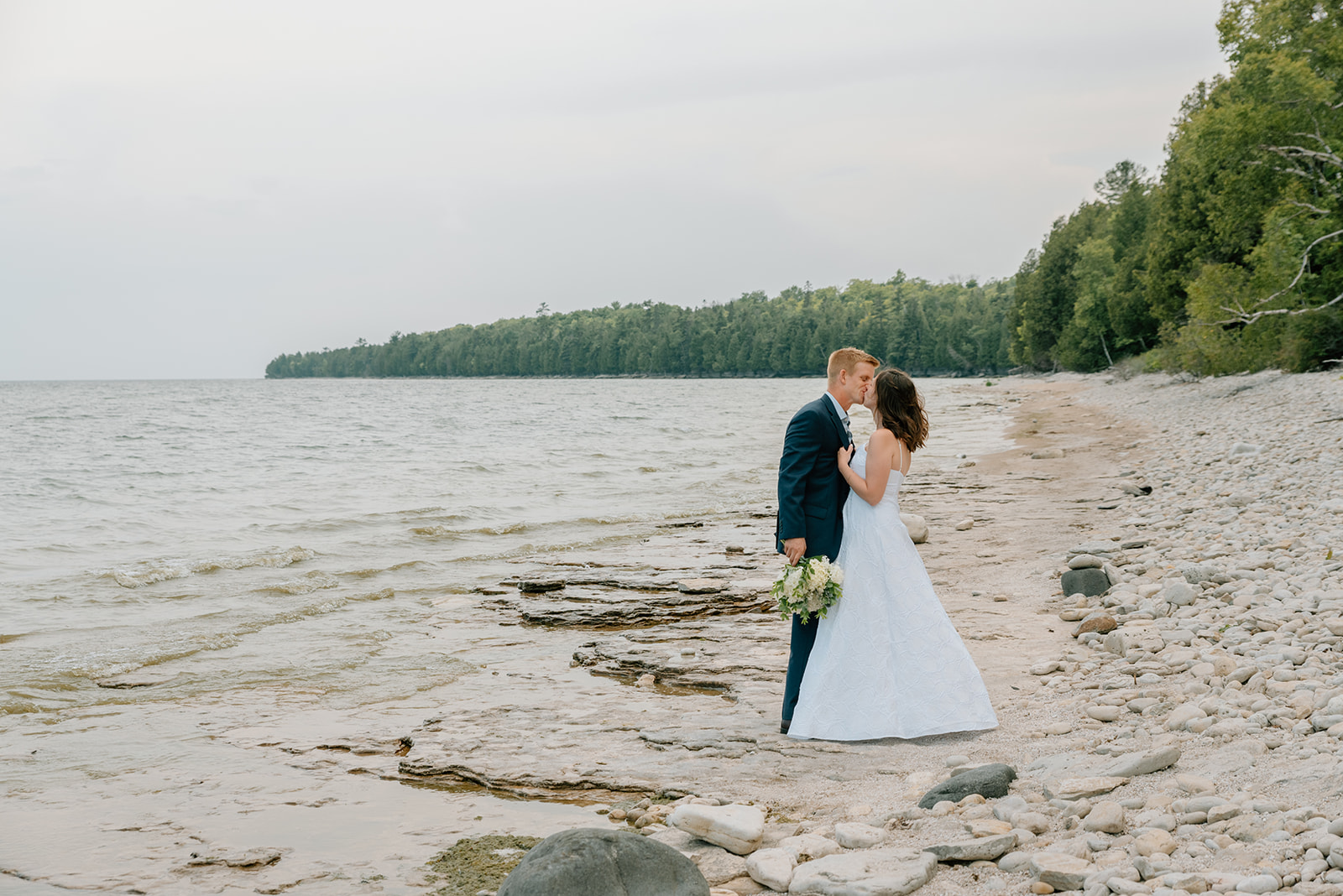Door County vow renewal on the rocky Lake Michigan shoreline husband and wife share quiet moment