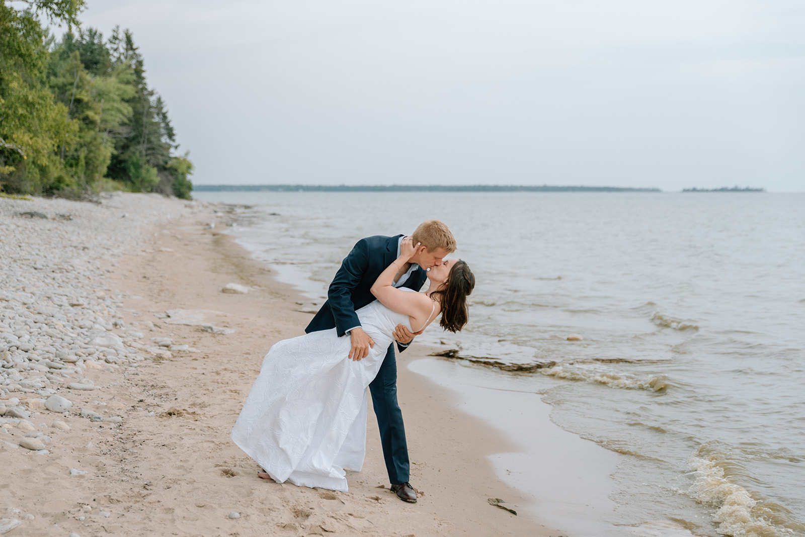Husband dips his wife for a kiss during their Door County vow renewal
