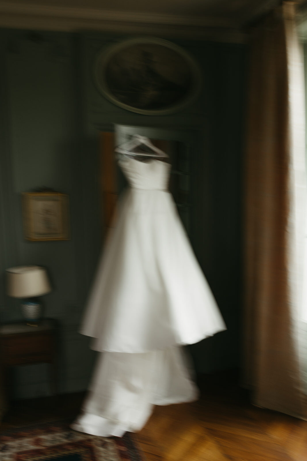 Bride's dress hanging in master suite of French Chateau