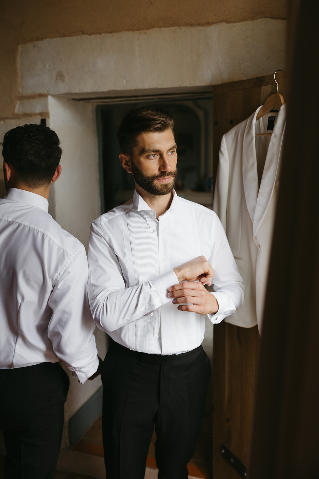 Groom getting dress in a French countryside cottage