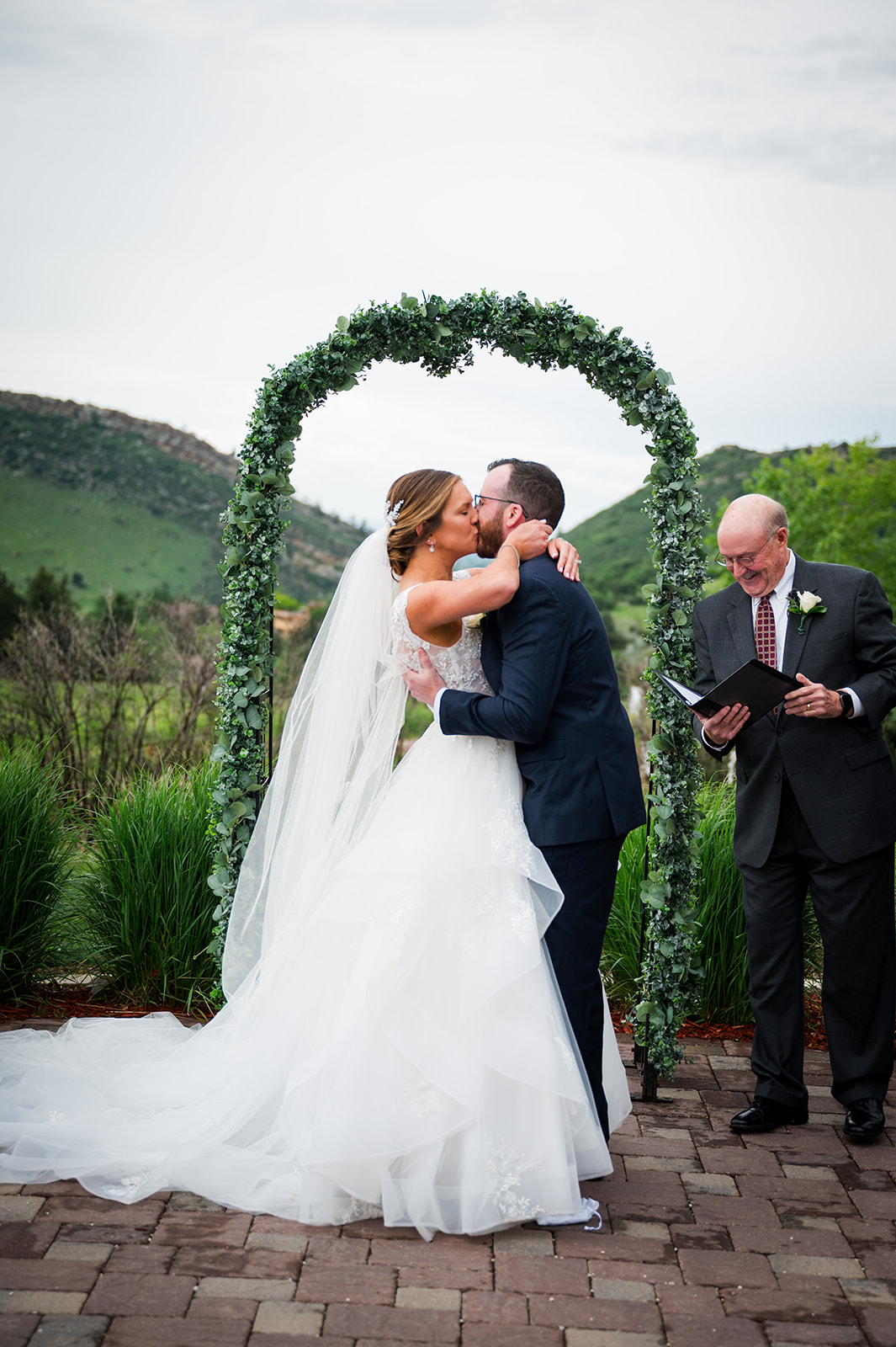Bride and groom share their first kiss at the end of their wedding ceremony.