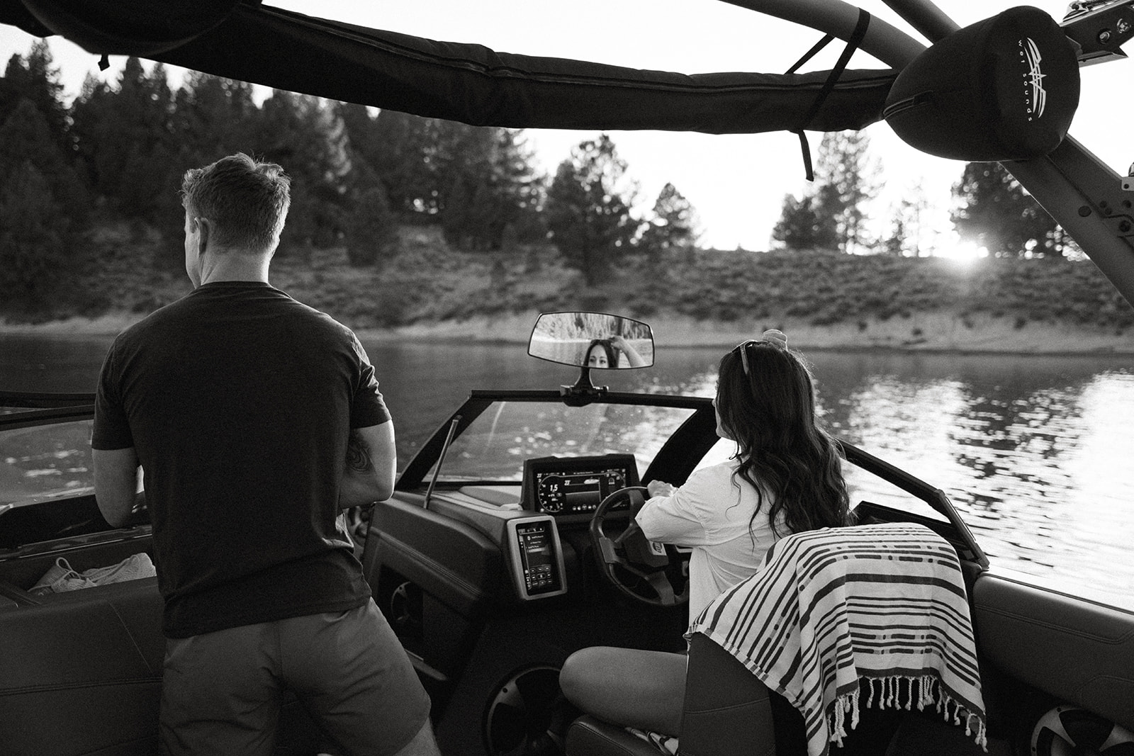 chasing sunsets on their surf boat in search of the perfect spot for sunset engagements on the lake in truckee ca