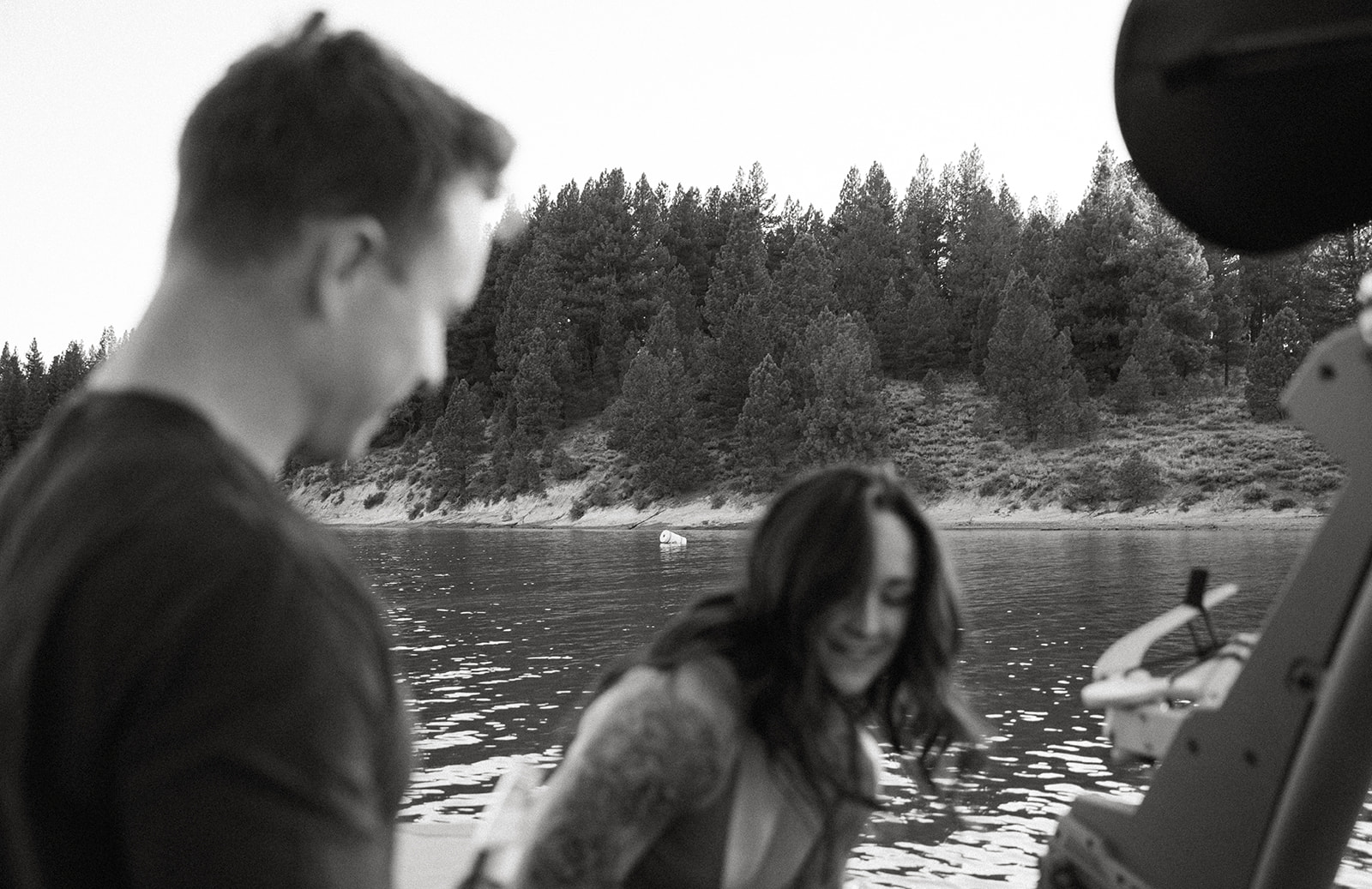 couple laughing during their lake engagement session