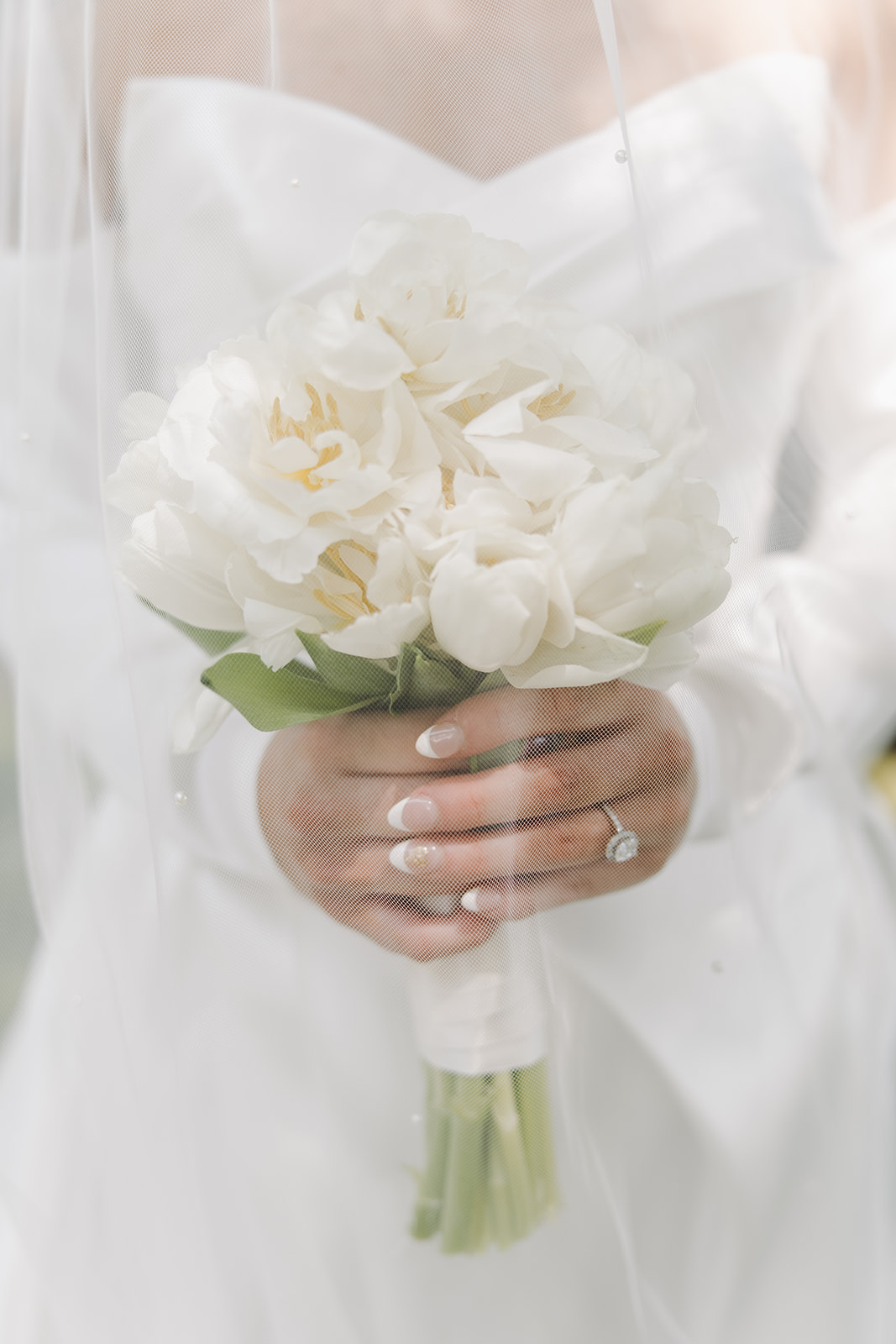 bride holds white wedding bouquet