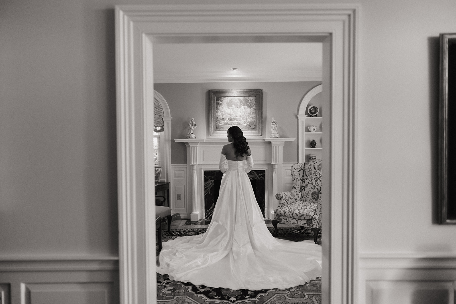 bride stands with long wedding dress train