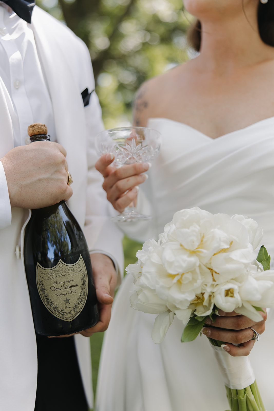 couple drinks champagne during wedding first look