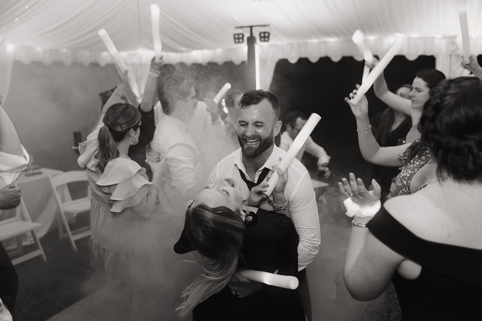 guests have dance party at outdoor wedding with tent 