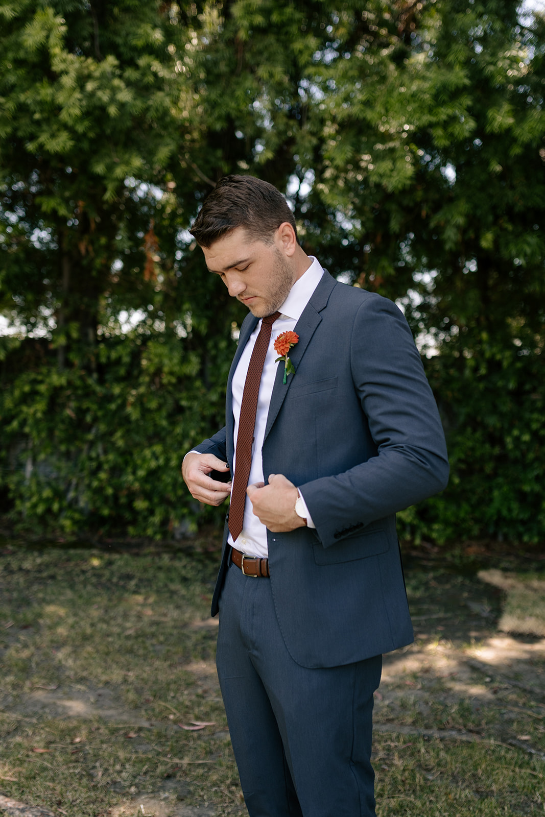 griffith house anaheim california socal orange county wedding groom portraits dark blue suit red boutonniere grey suit