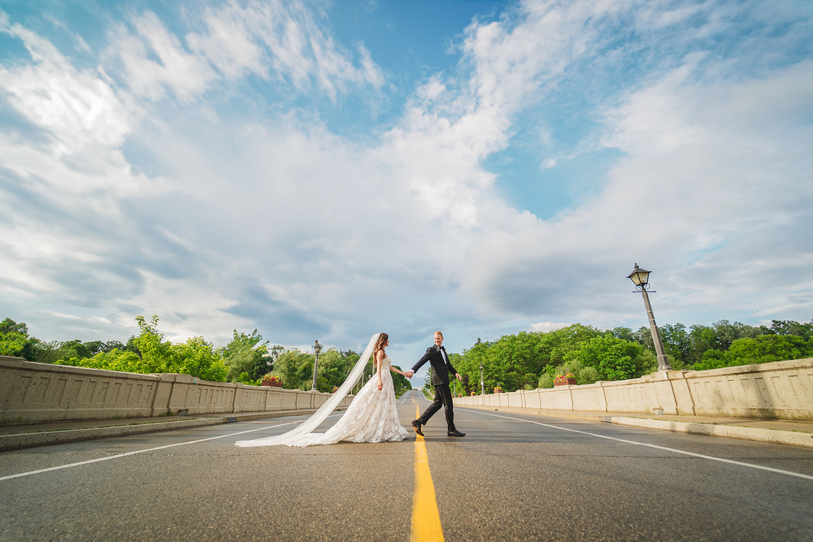 bride and groom walking across the street st jacobs