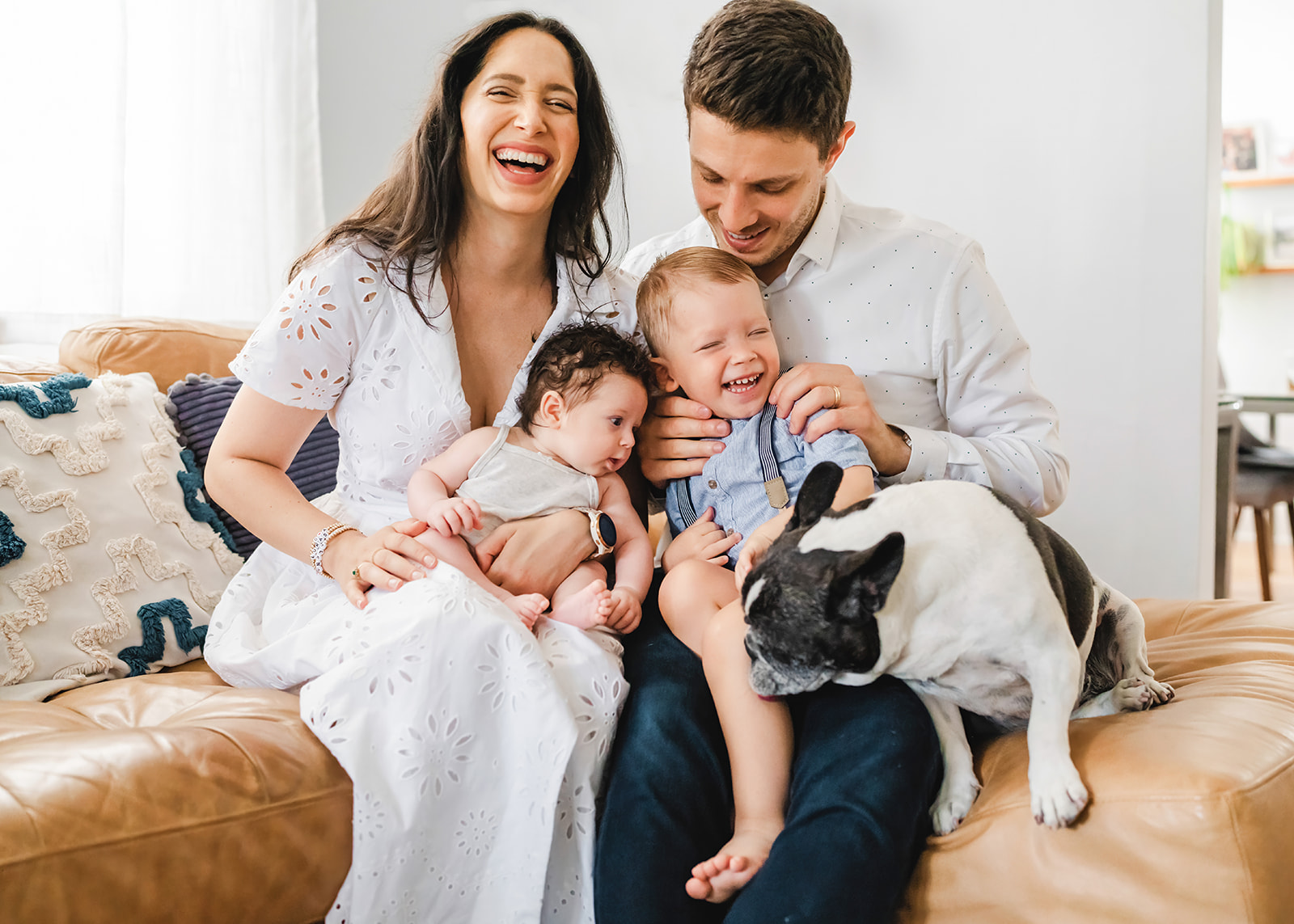 New York City family at home with newborn and dog.