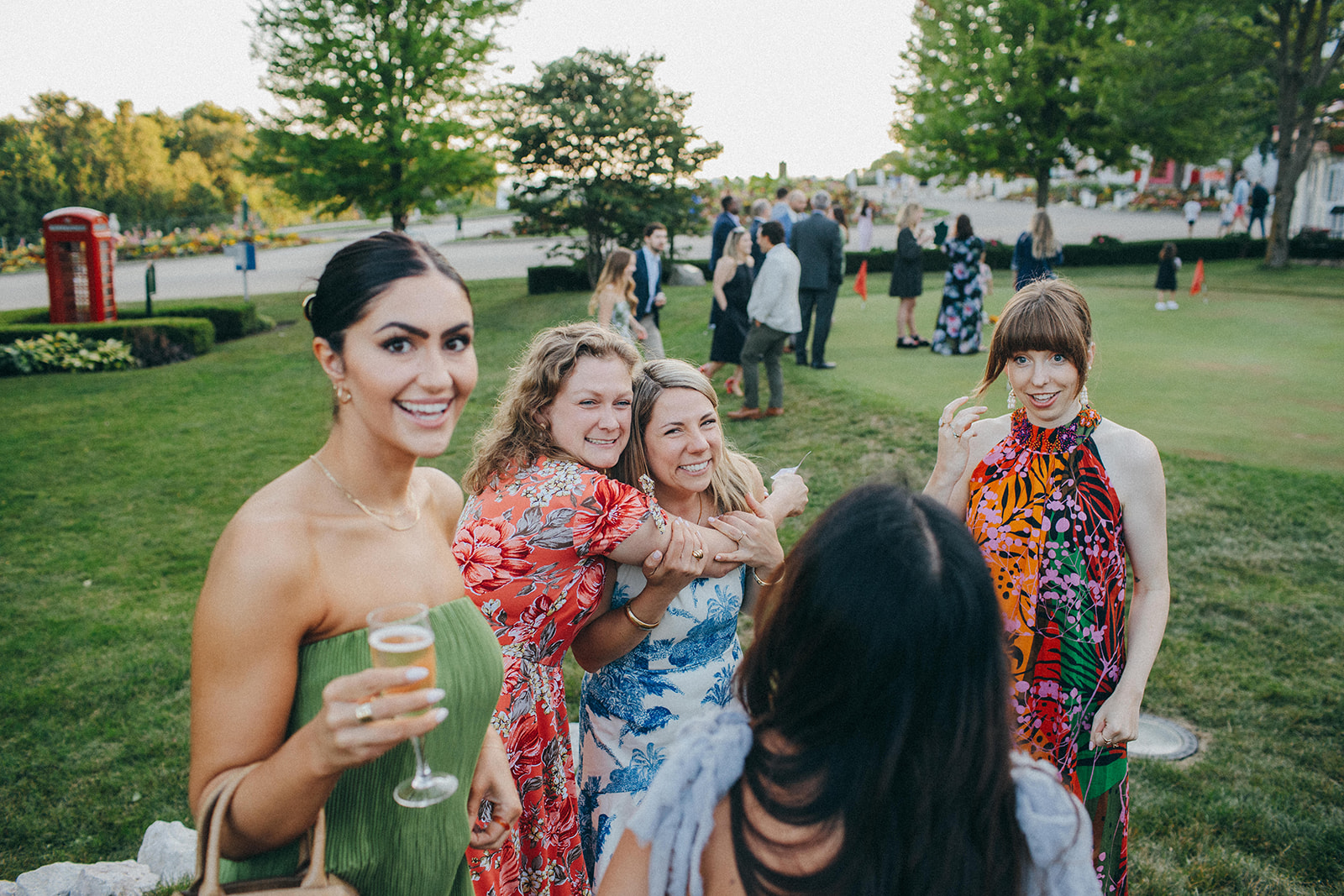A bride and her friends in colorful dresses for the wedding welcome party at the Jockey Club in the Grand Hotel, MI
