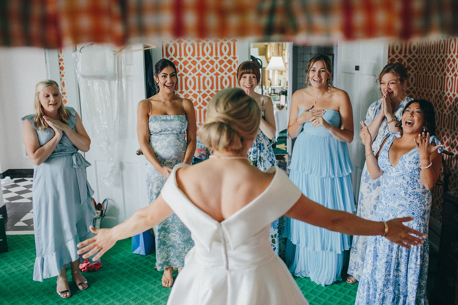 A bride shares an emotional and fun moment with her friends in the Presidents Suite at the Grand Hotel on Mackinac