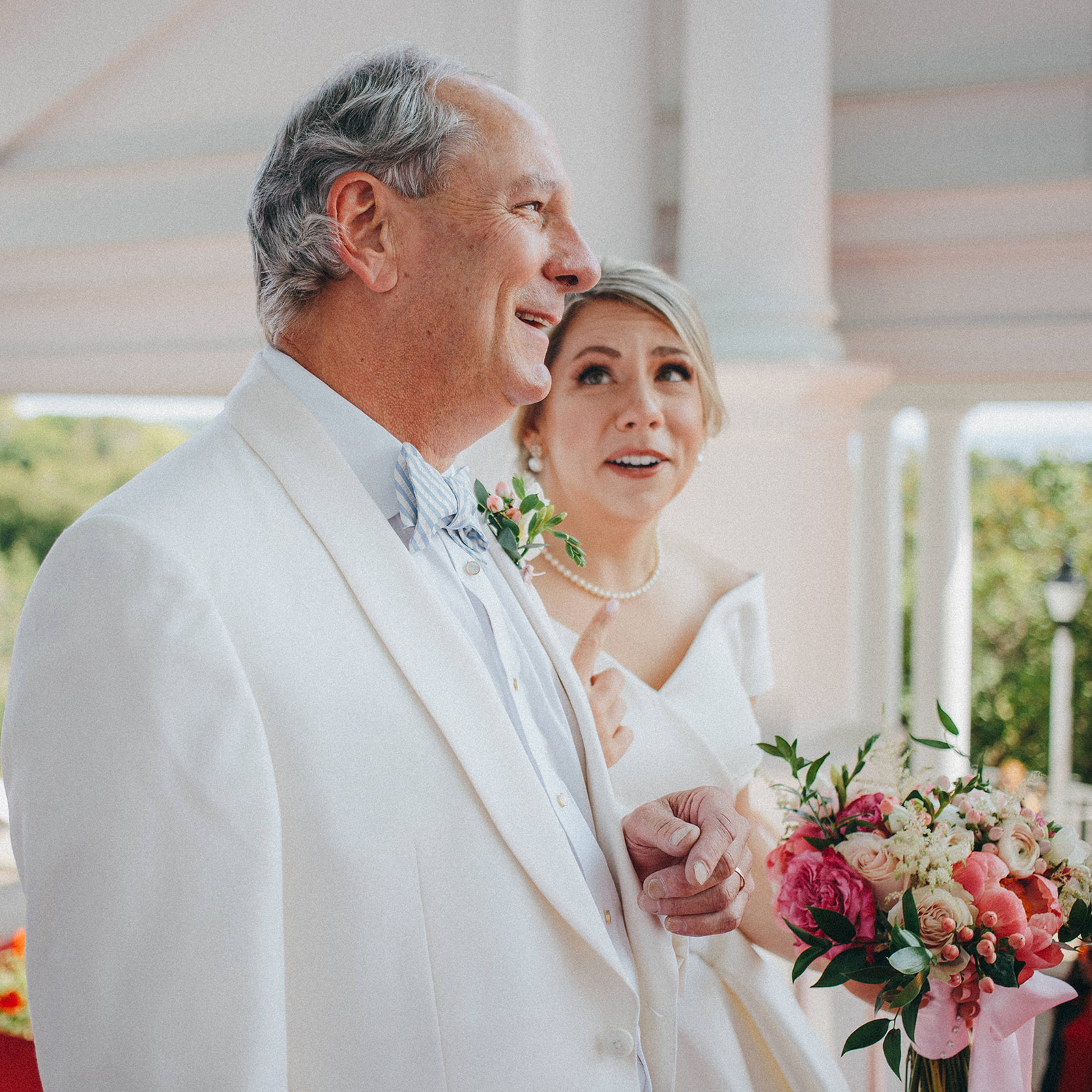 A bride and her dad share a moment before walking down the aisle at the Grand Hotel on Mackinac Island