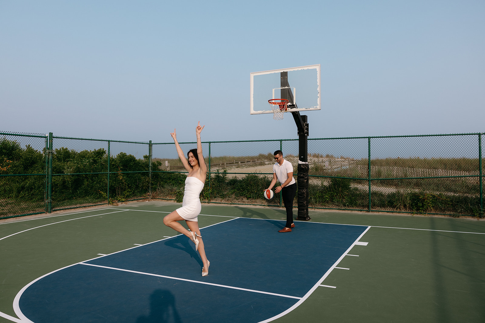 A candid couple engagement session on a basketball court