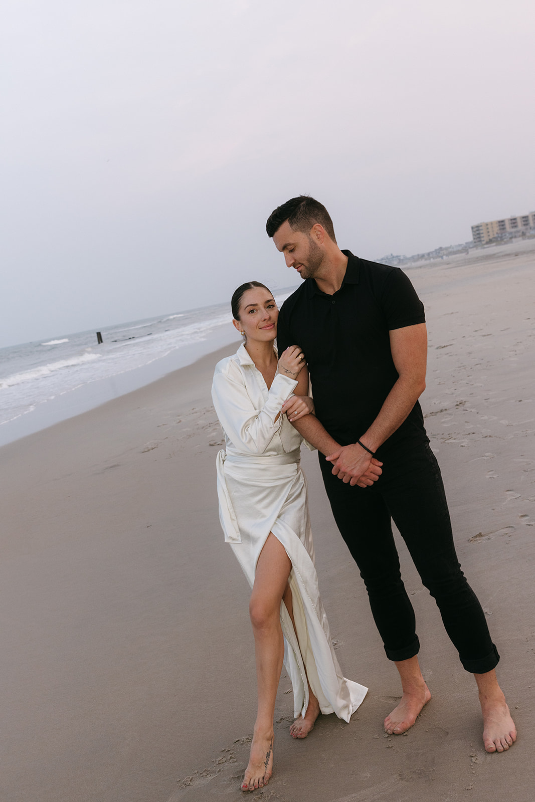 An editorial couple engagement session on a New Jersey beach with direct flash