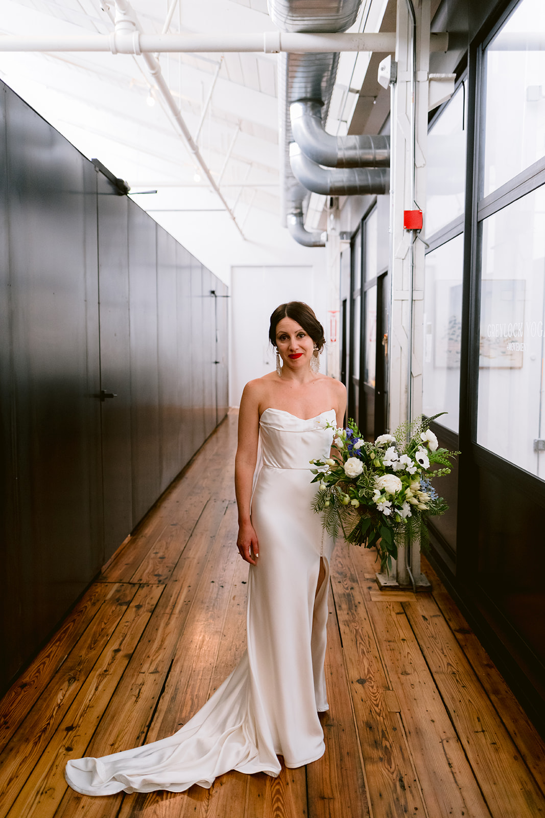 A bride poses for the camera at Greylock Works in Massachusetts's. 