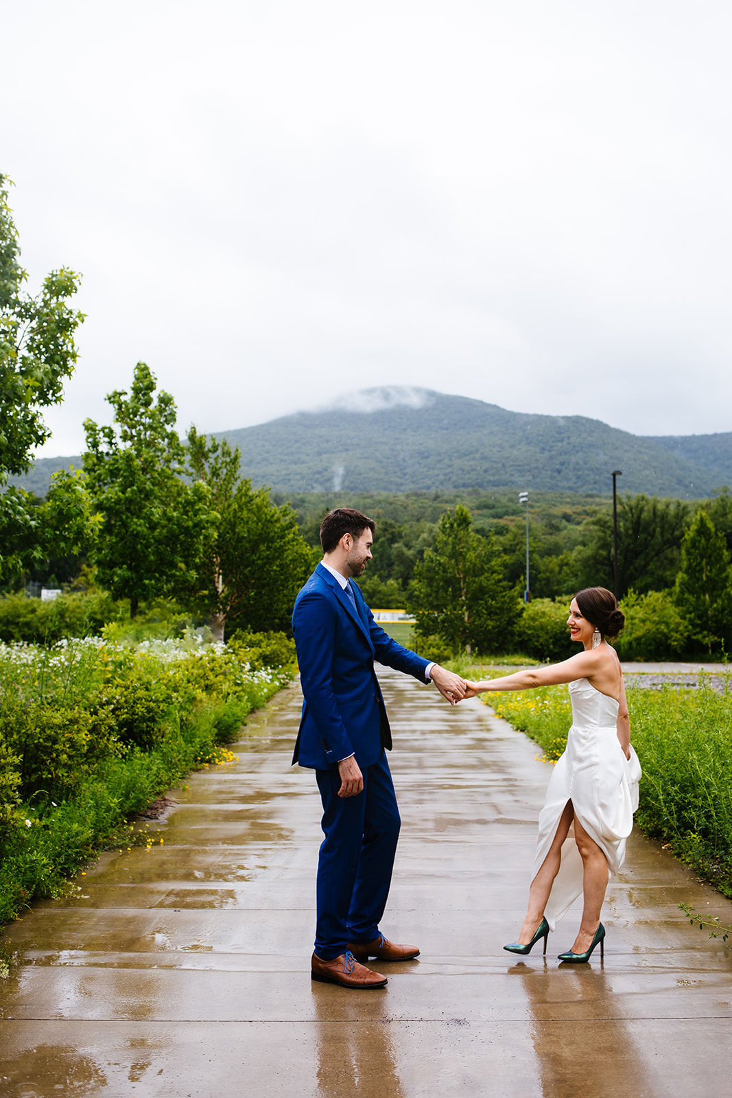 Bride and groom dance in the rain