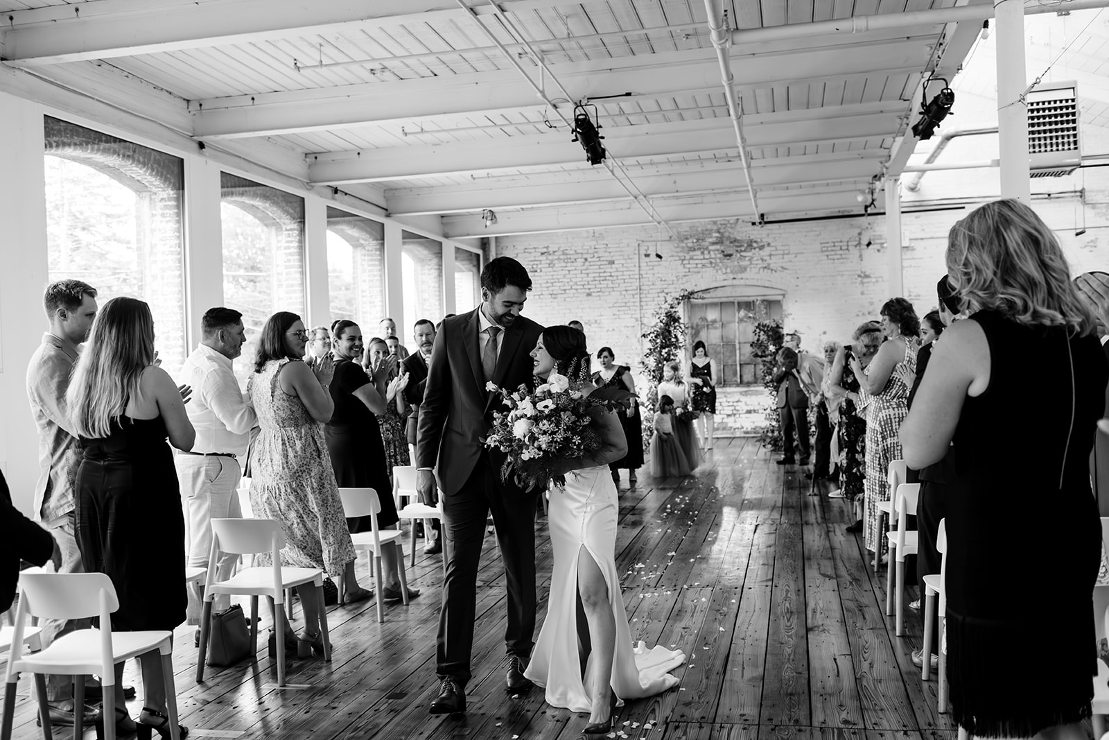 Bride and groom walk back down the aisle after being married. 