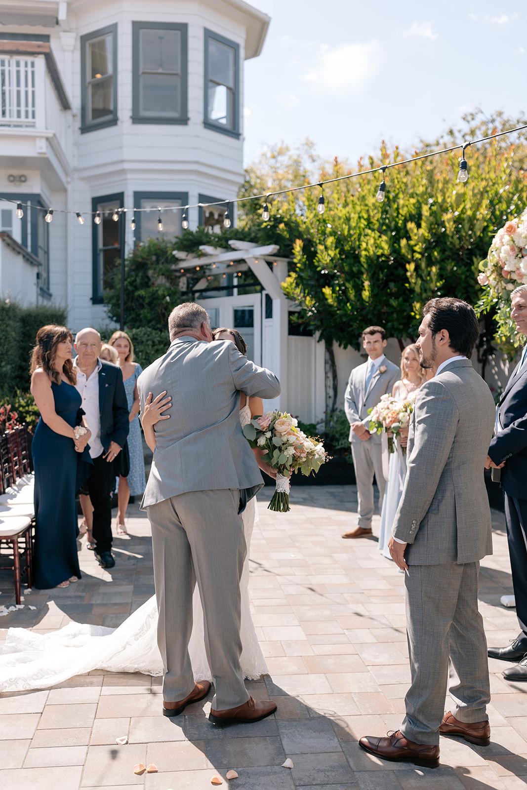 the perry house wedding monterey california outdoor ceremony gray wedding suit groom walking down aisle ceremony ideas