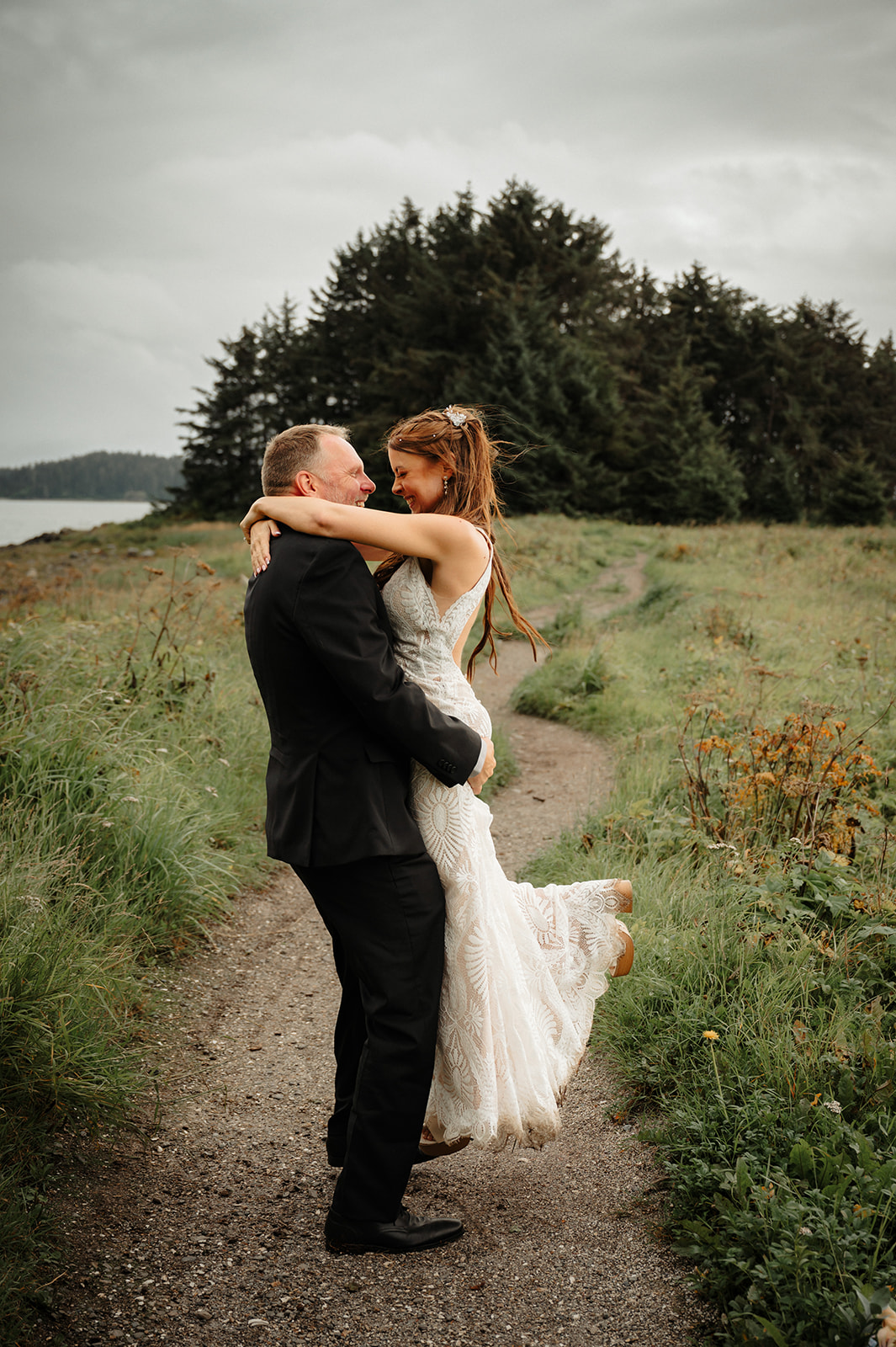 Romantic beach elopement bride and groom spinning in Juneau Alaska