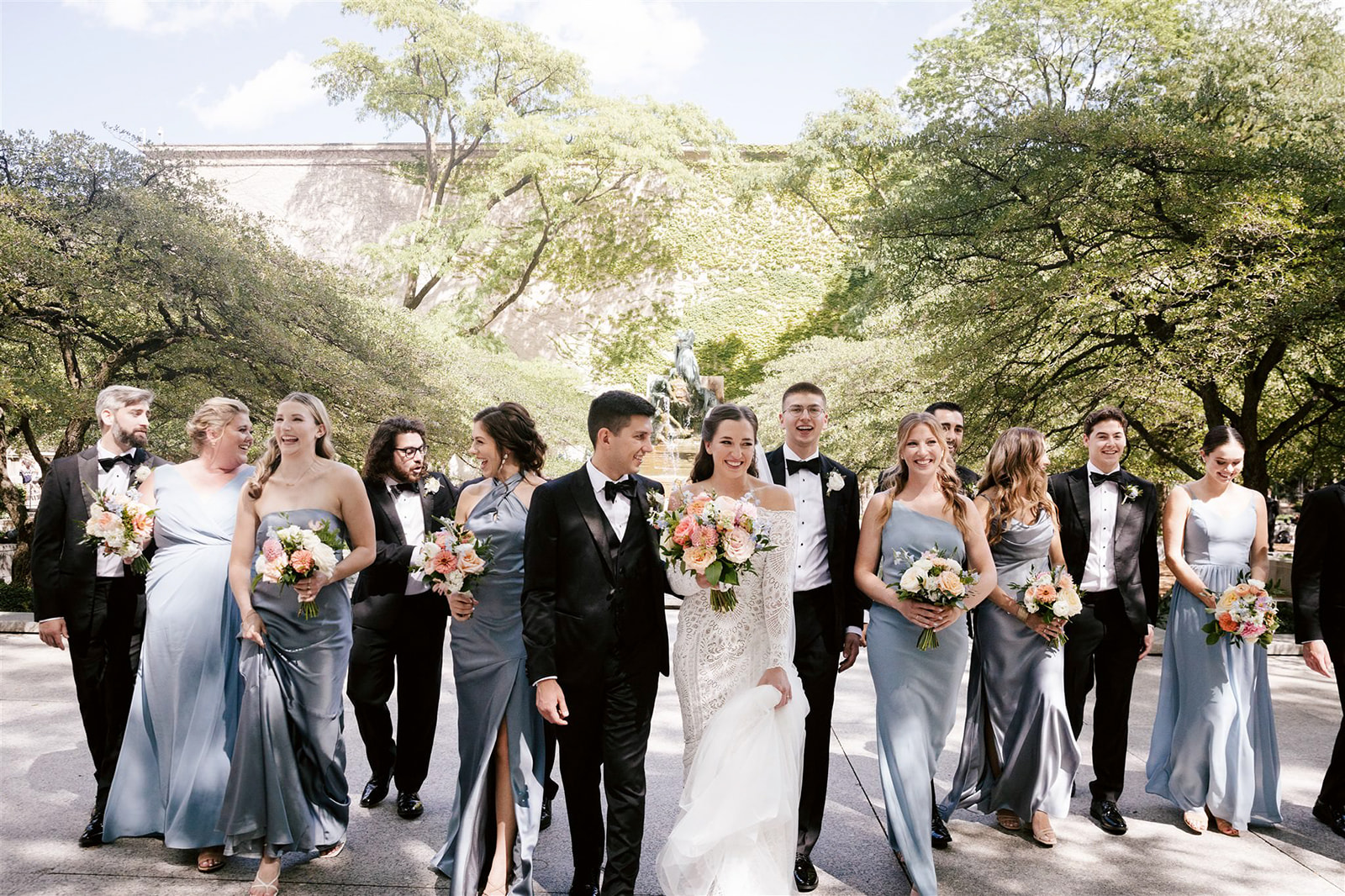 Amidst Chicago's Art Institute gardens, a picturesque gathering of the wedding party unfolds in elegant splendor.