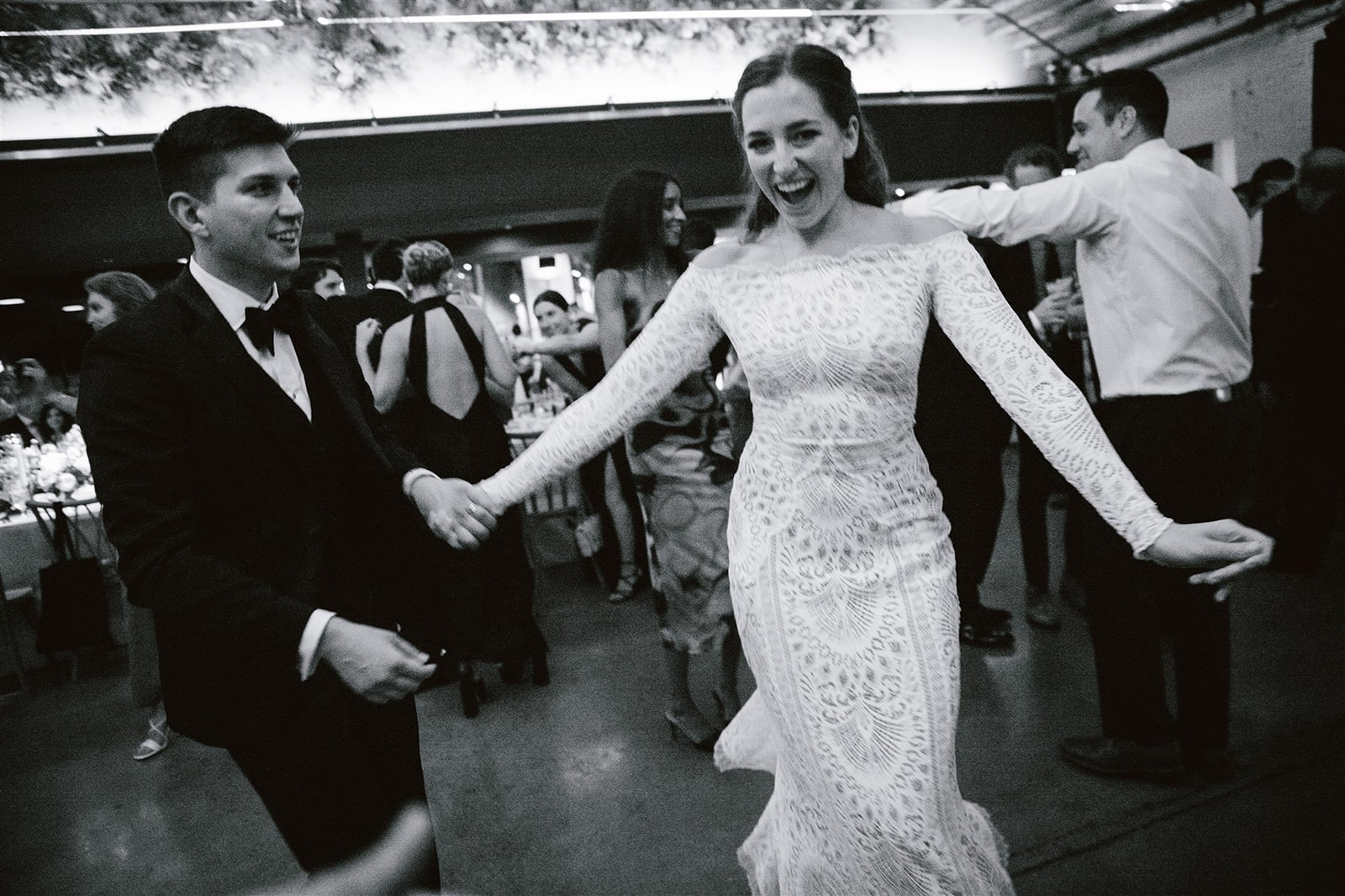 Bride and groom dancing joyfully at Walden Chicago wedding celebration.