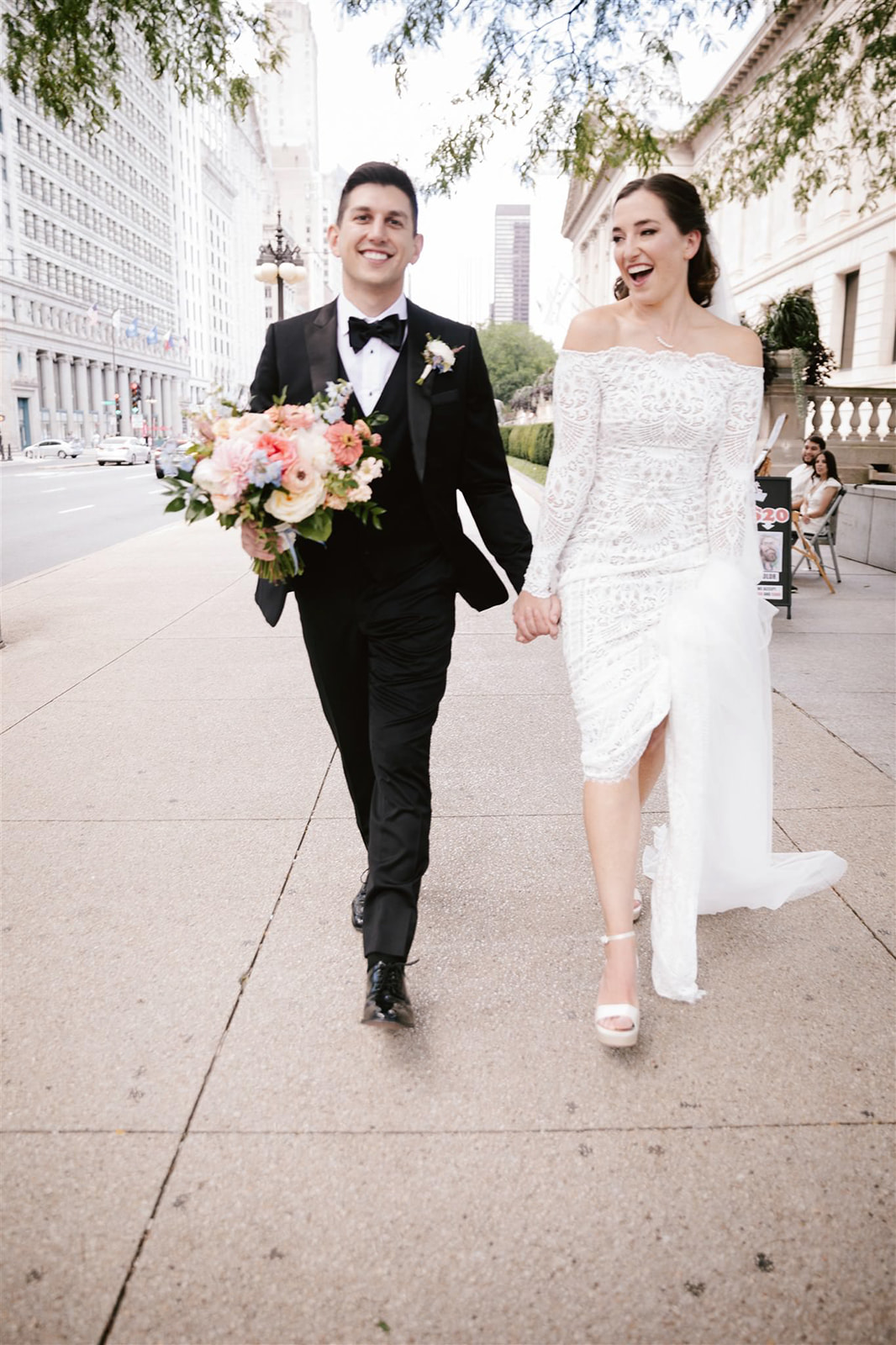 Exploring Chicago's urban charm, the bride and groom strolling down the city streets.