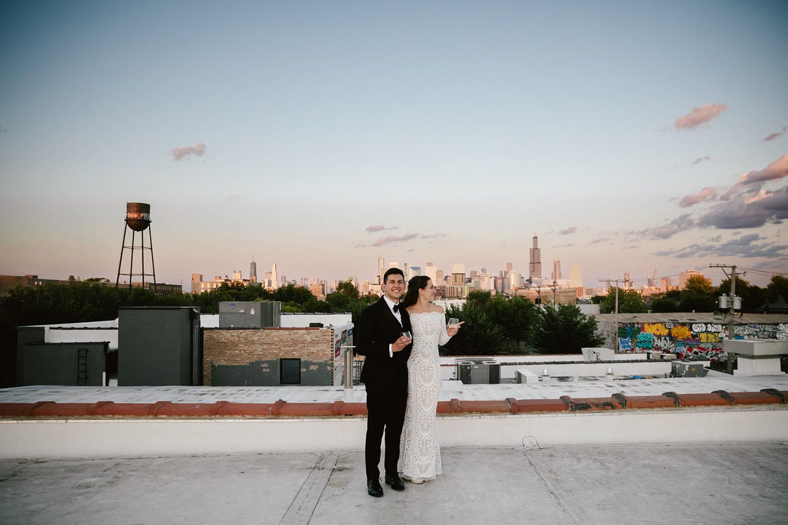 Sunset bliss: Newlyweds at Walden Chicago's rooftop, sharing a moment of pure love against the city skyline.