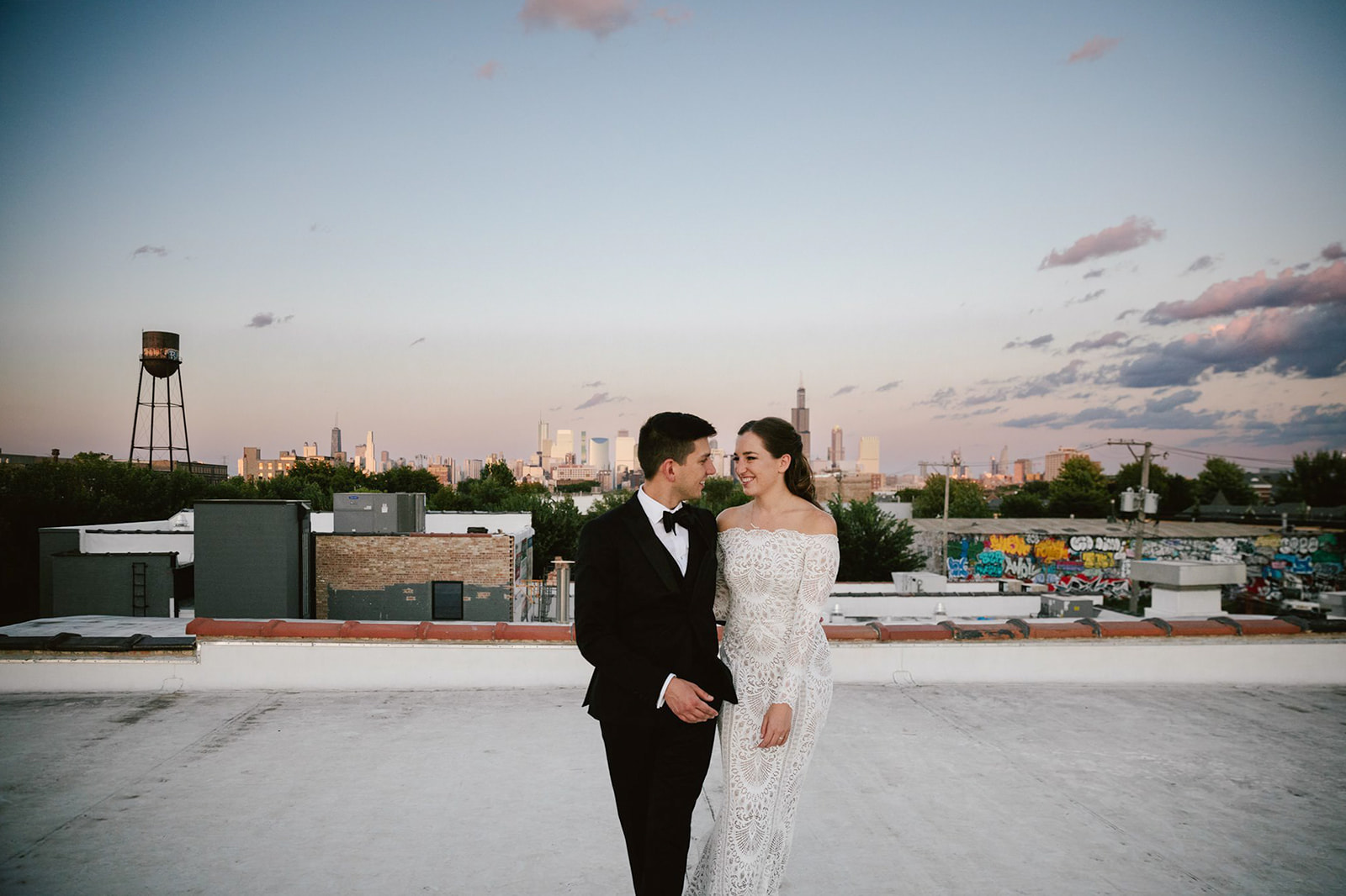 Sunset bliss: Newlyweds at Walden Chicago's rooftop, sharing a moment of pure love against the city skyline.
