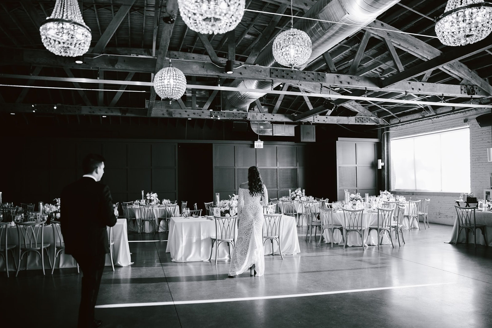 The bride and groom share a delighted reaction upon seeing their reception space at Walden Chicago.