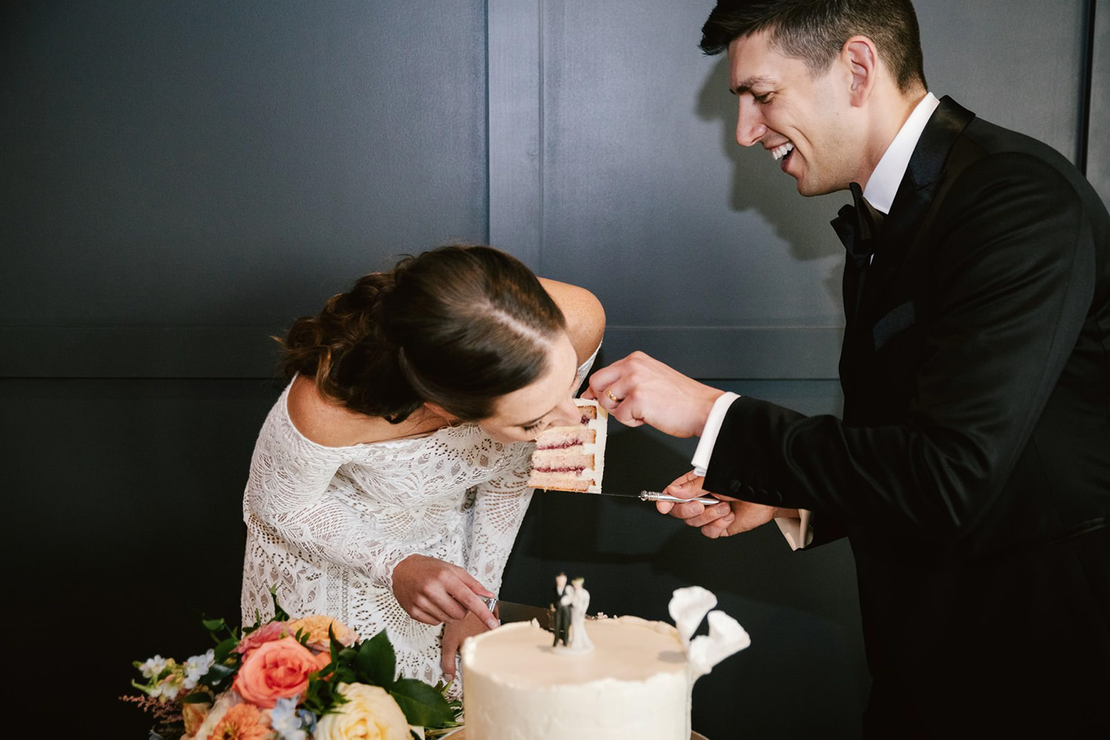 The bride and groom share a private and lighthearted cake-cutting moment at Walden Chicago.