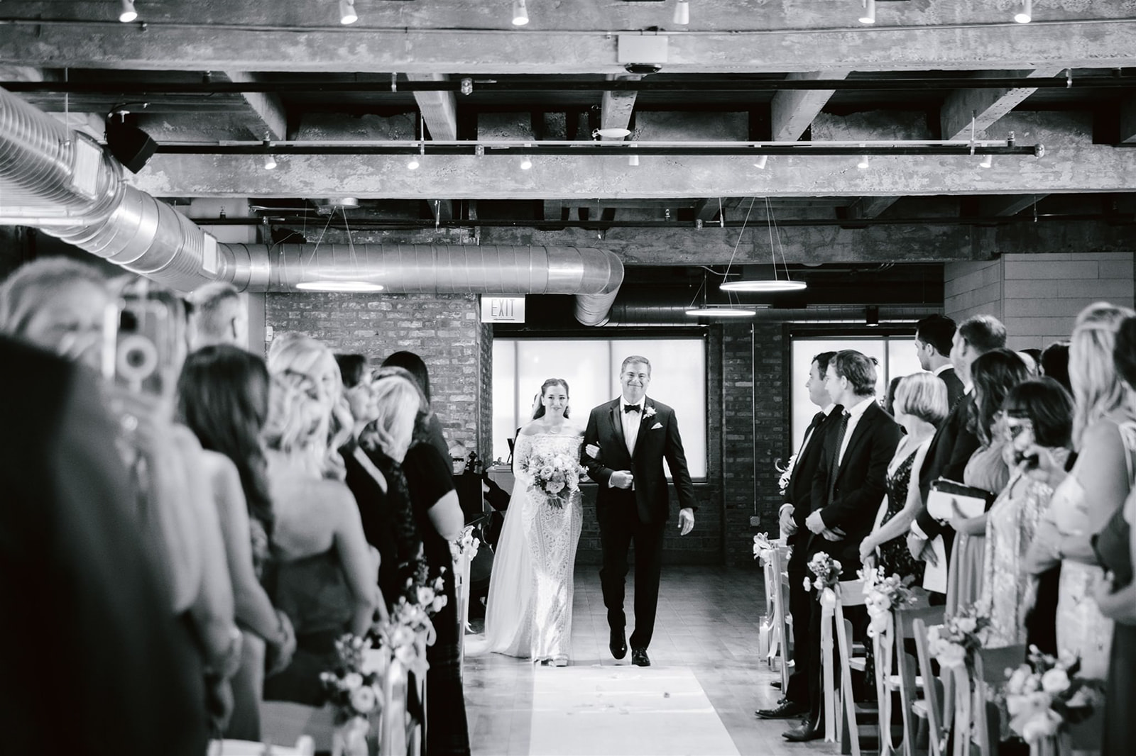 The bride's emotional walk down the aisle, accompanied by her proud father at Walden Chicago.