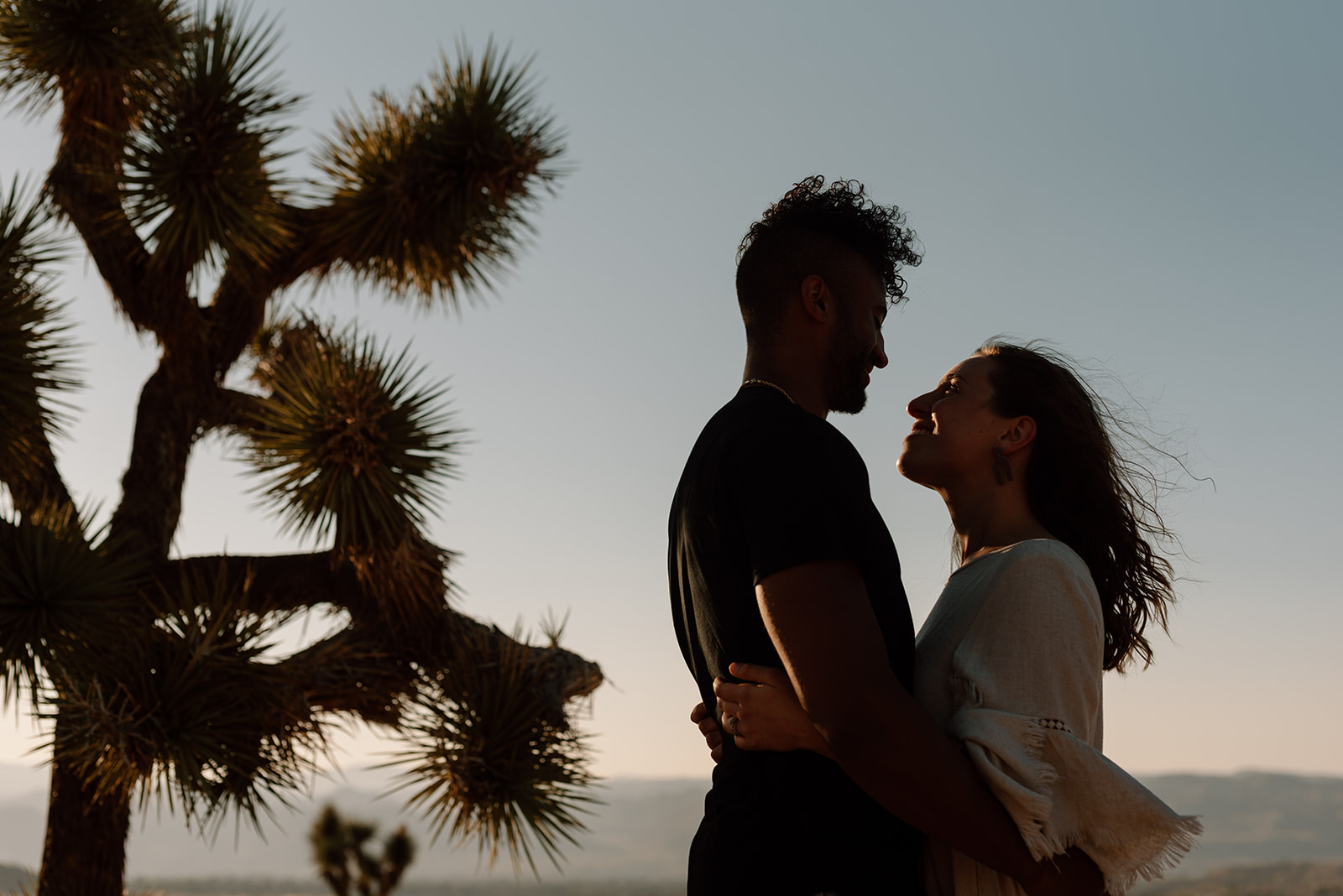 Silhouette at sunset with cactus in background Joshua Tree National Park engagement photography