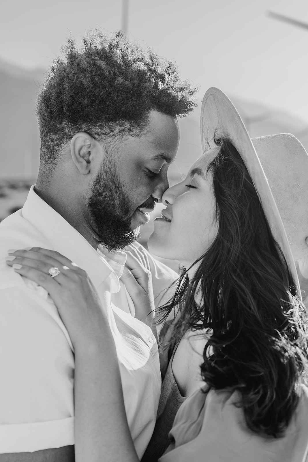 Black and white photo of engaged couple nose to nose