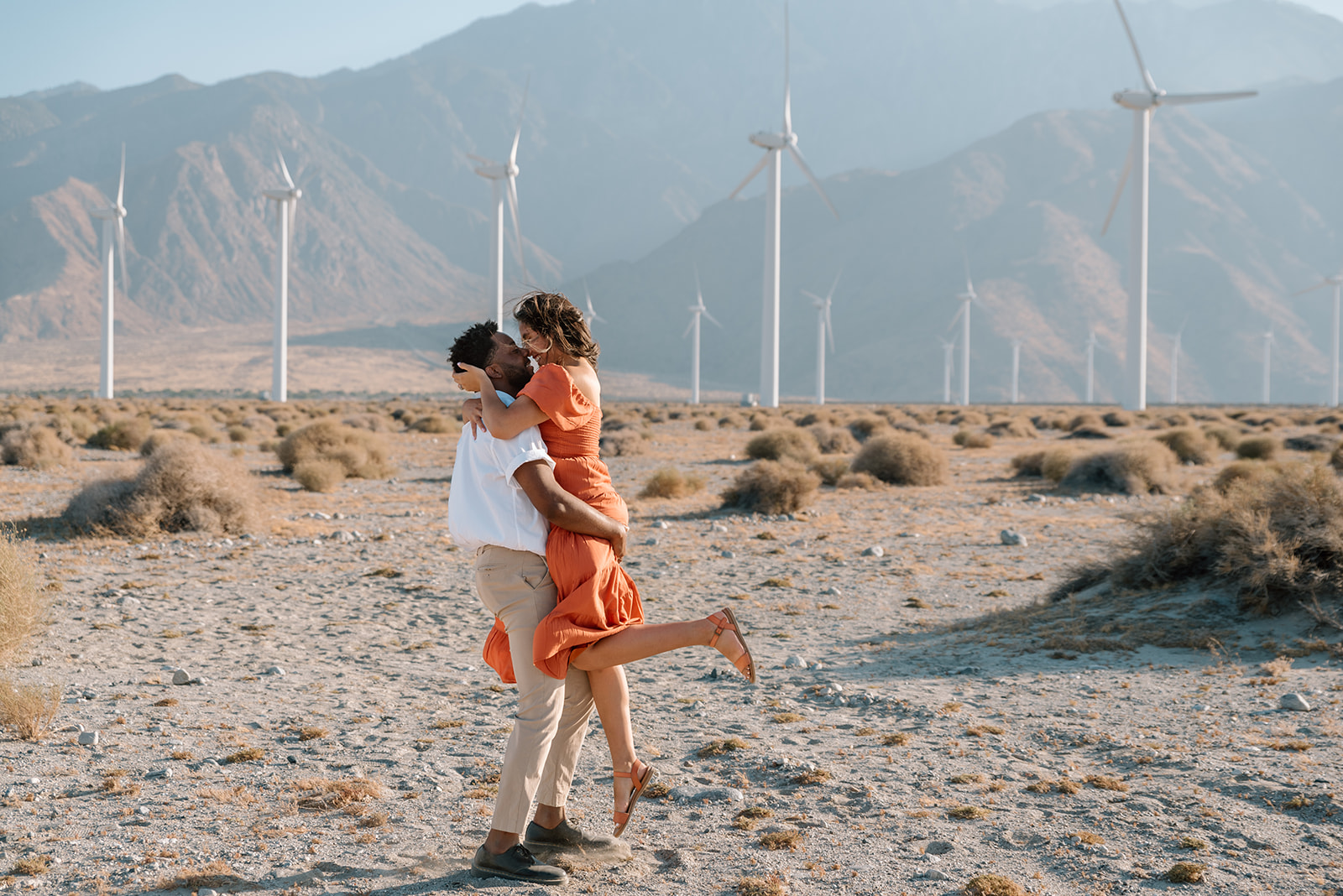 Man and woman embrace in the Palm Springs desert